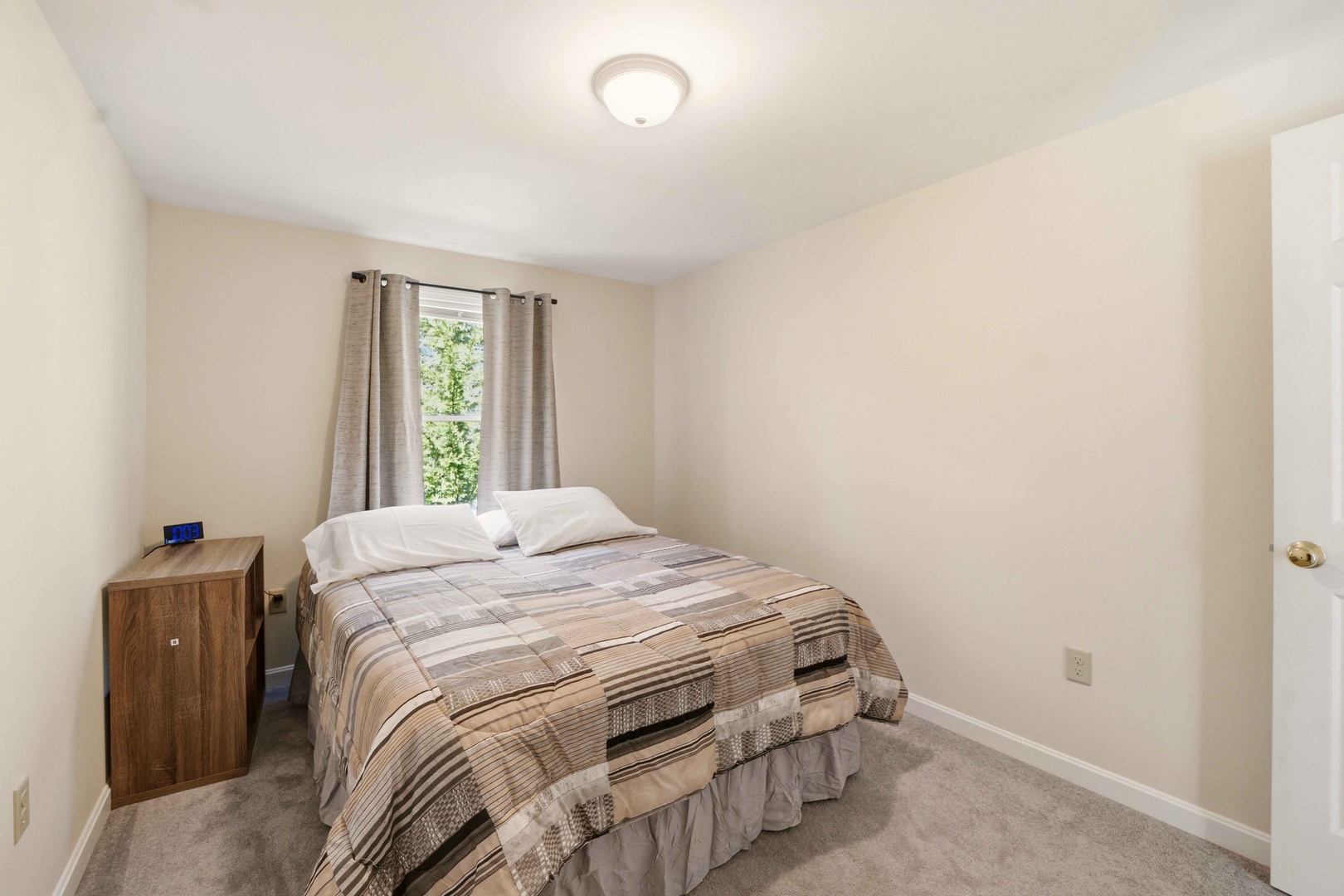 Your peaceful bedroom features a comfortable bed with soft linens, warm natural light, and cozy furnishings for restful nights.
