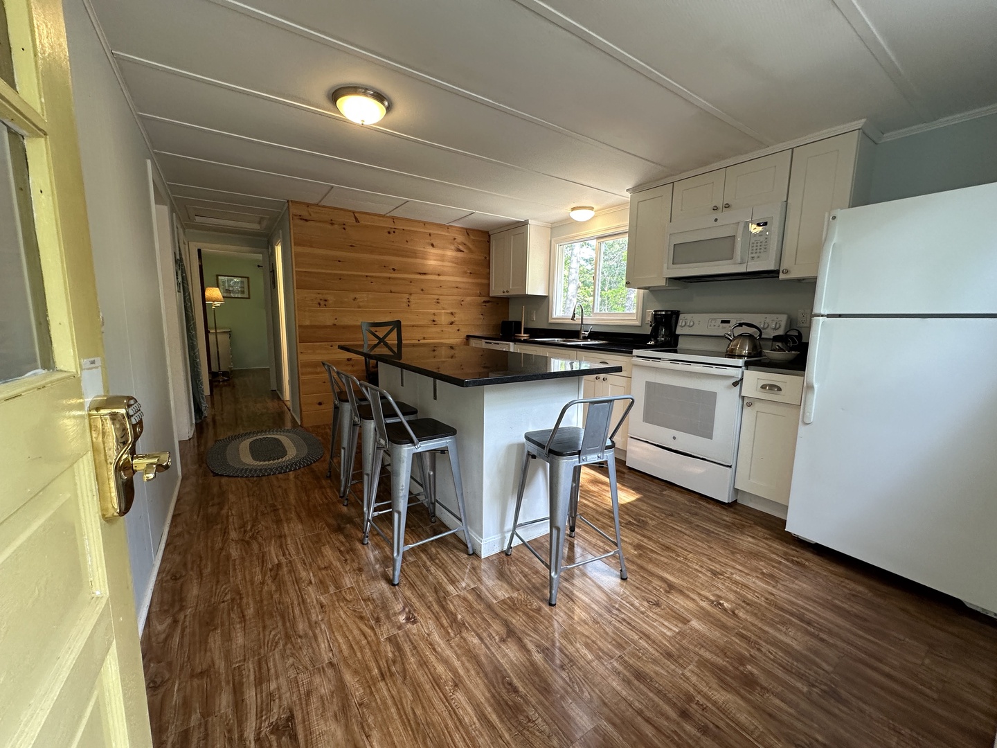 Your fully equipped kitchen features modern appliances, granite countertops, and a breakfast bar where you can enjoy morning coffee together.