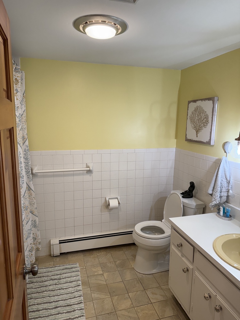 Your private bathroom features a walk-in shower, modern fixtures, and coastal-inspired décor—perfect for refreshing after a day of exploration.