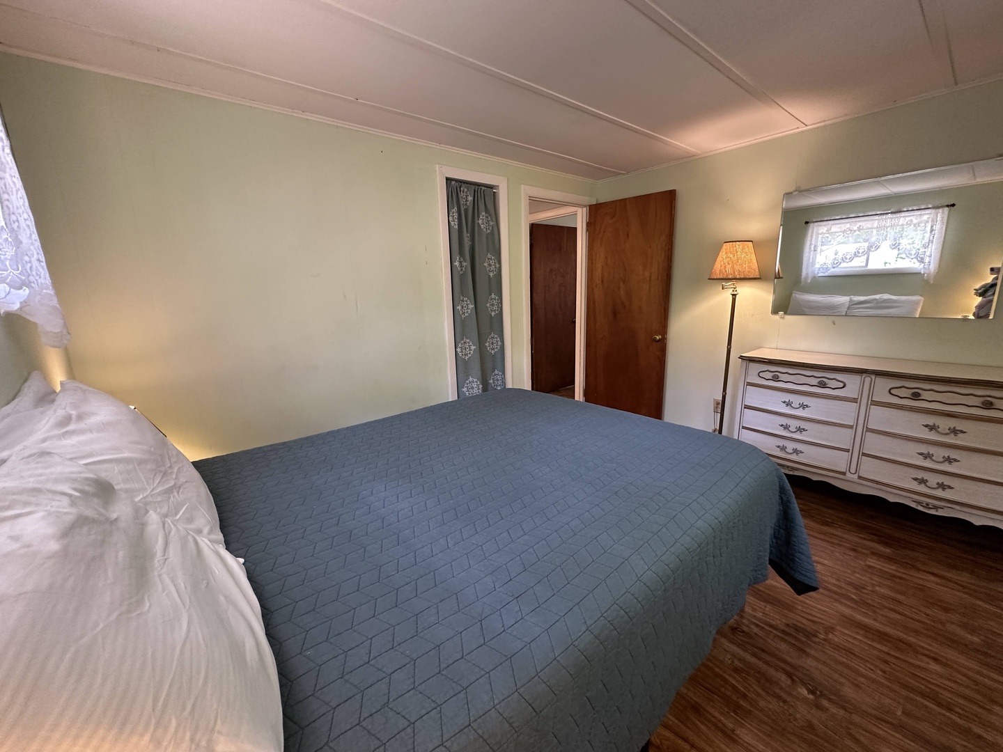 Drift off to sleep in your cozy bedroom, where warm lighting and vintage furnishings create a peaceful retreat after your day of adventures.