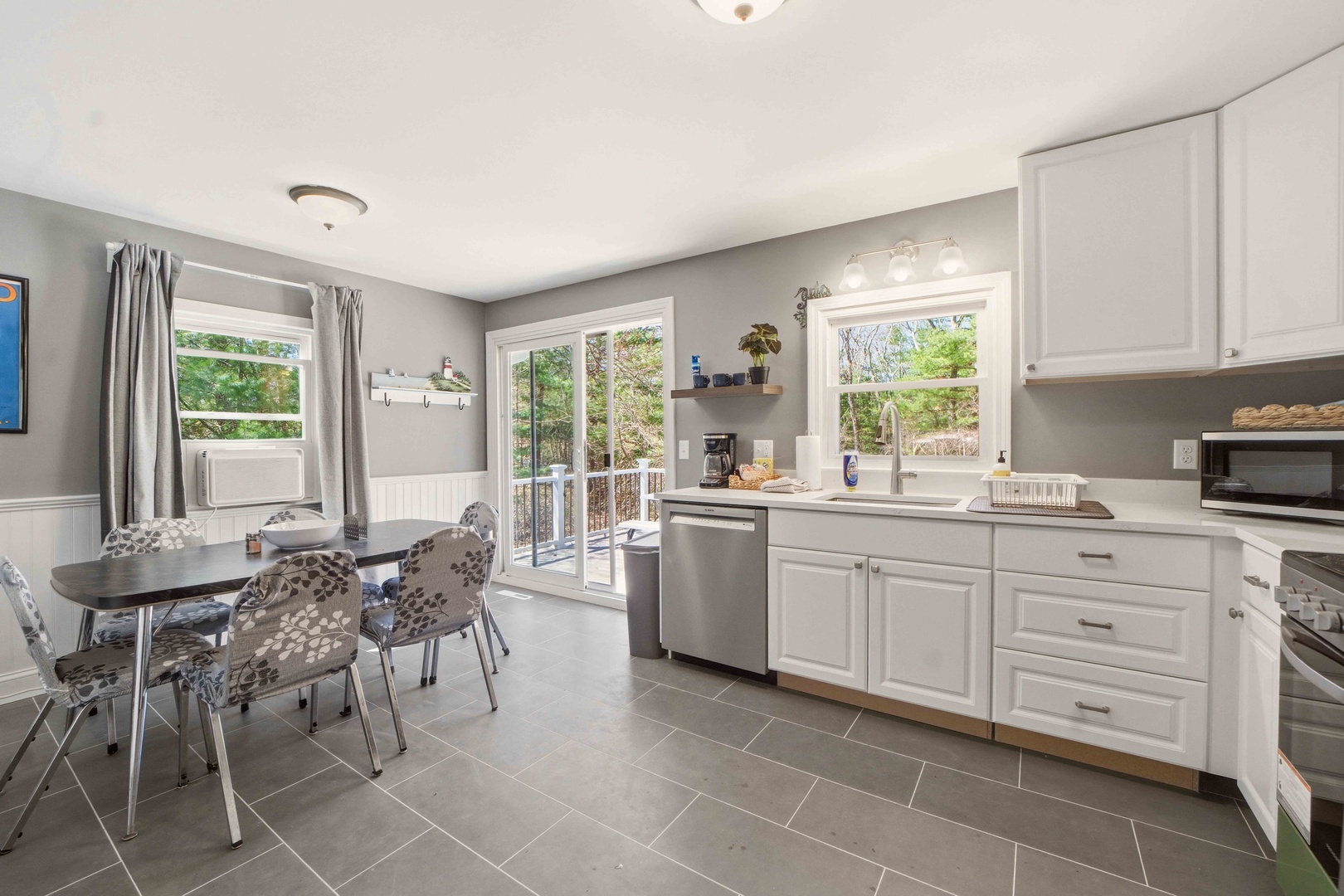 Cook your favorite meals in this bright, fully-equipped kitchen with stainless steel appliances and dining space overlooking peaceful trees.
