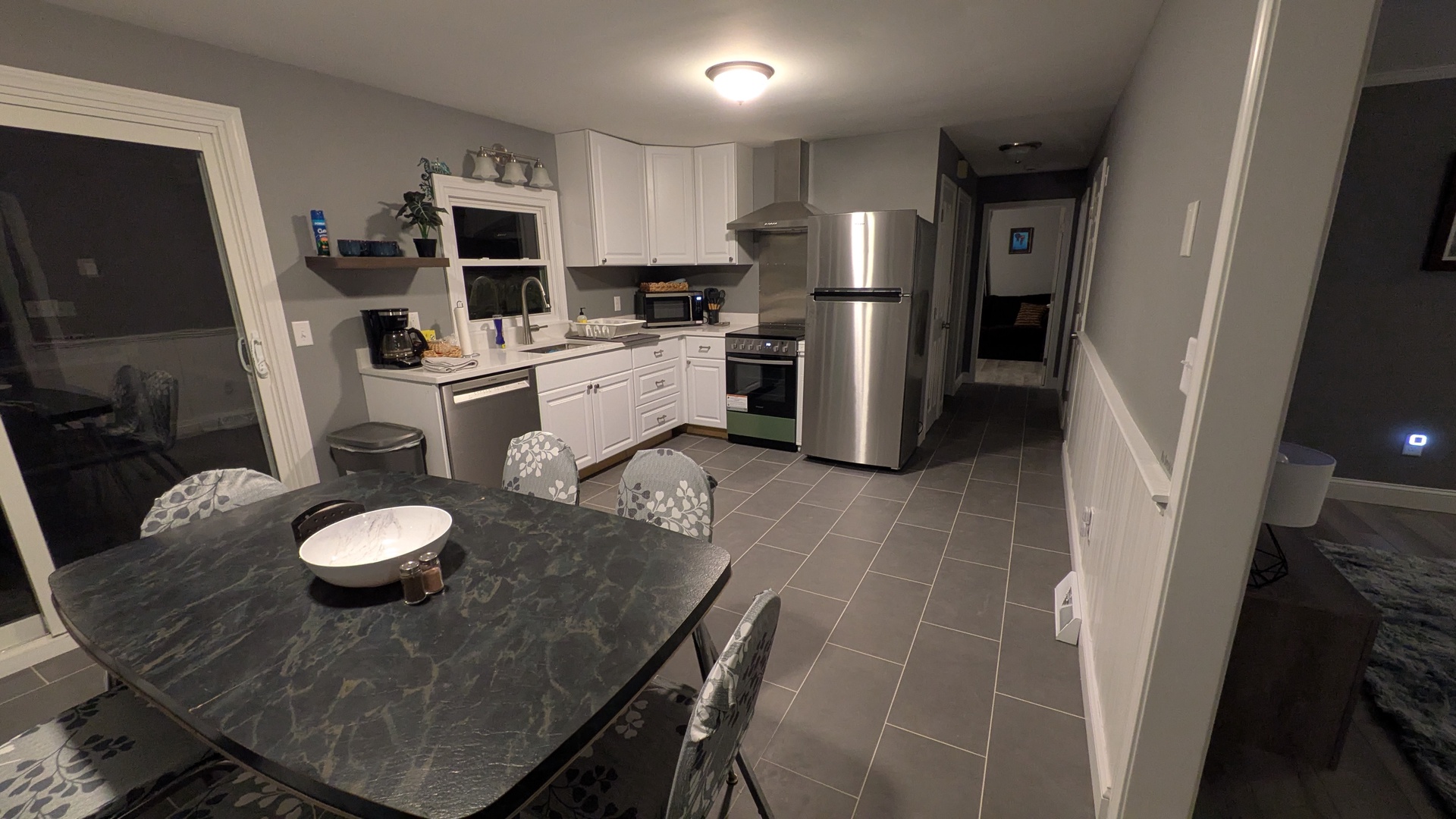 Your spacious kitchen invites culinary adventures with stainless steel appliances, granite counters, and a cozy dining table perfect for morning coffee or evening meals.