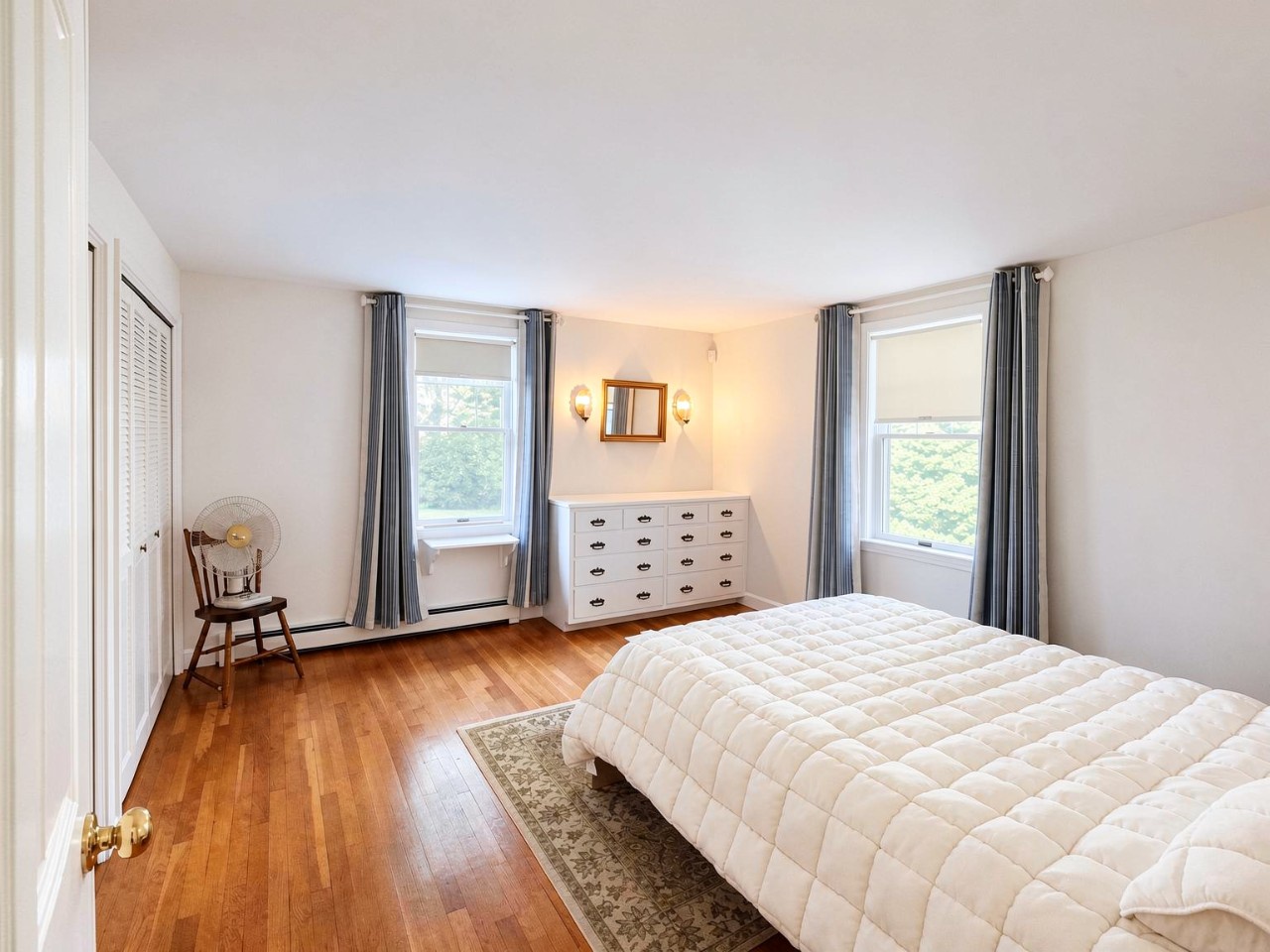 Sink into your cozy retreat with warm wood floors, natural light from dual windows, and gentle breezes through the trees—your peaceful escape awaits.