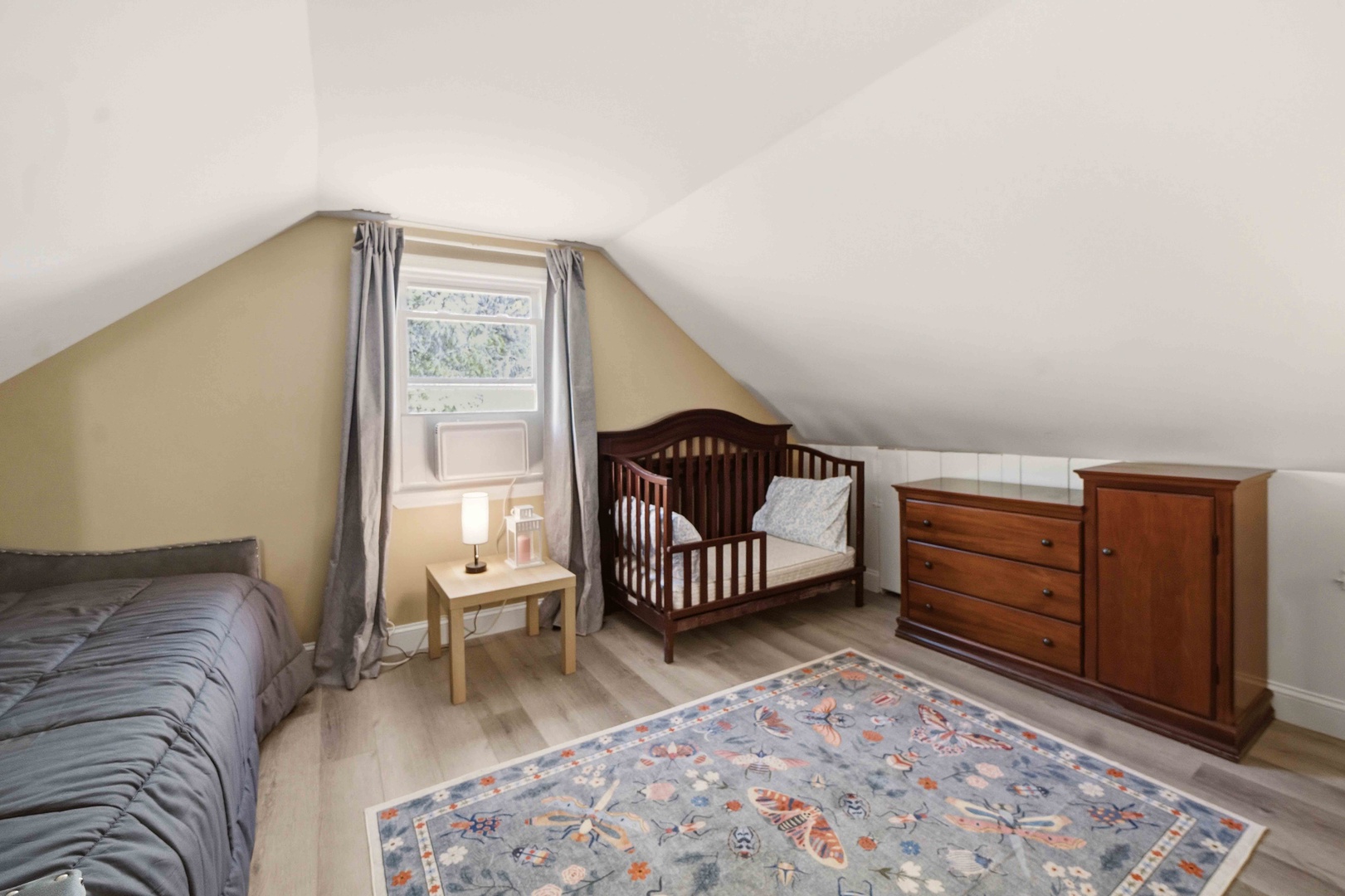 Your cozy second floor bedroom features a convertible crib and dresser, perfect for families with little ones needing their own space.