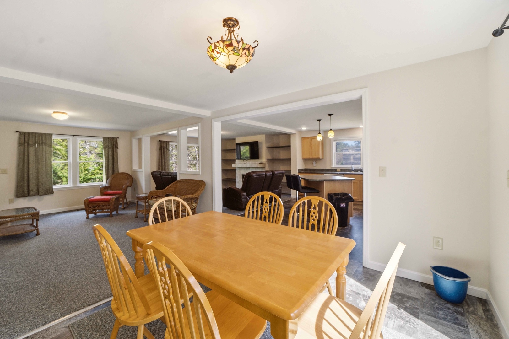 Gather around your spacious dining table for memorable meals, with an elegant chandelier overhead and open views to your comfortable living area.