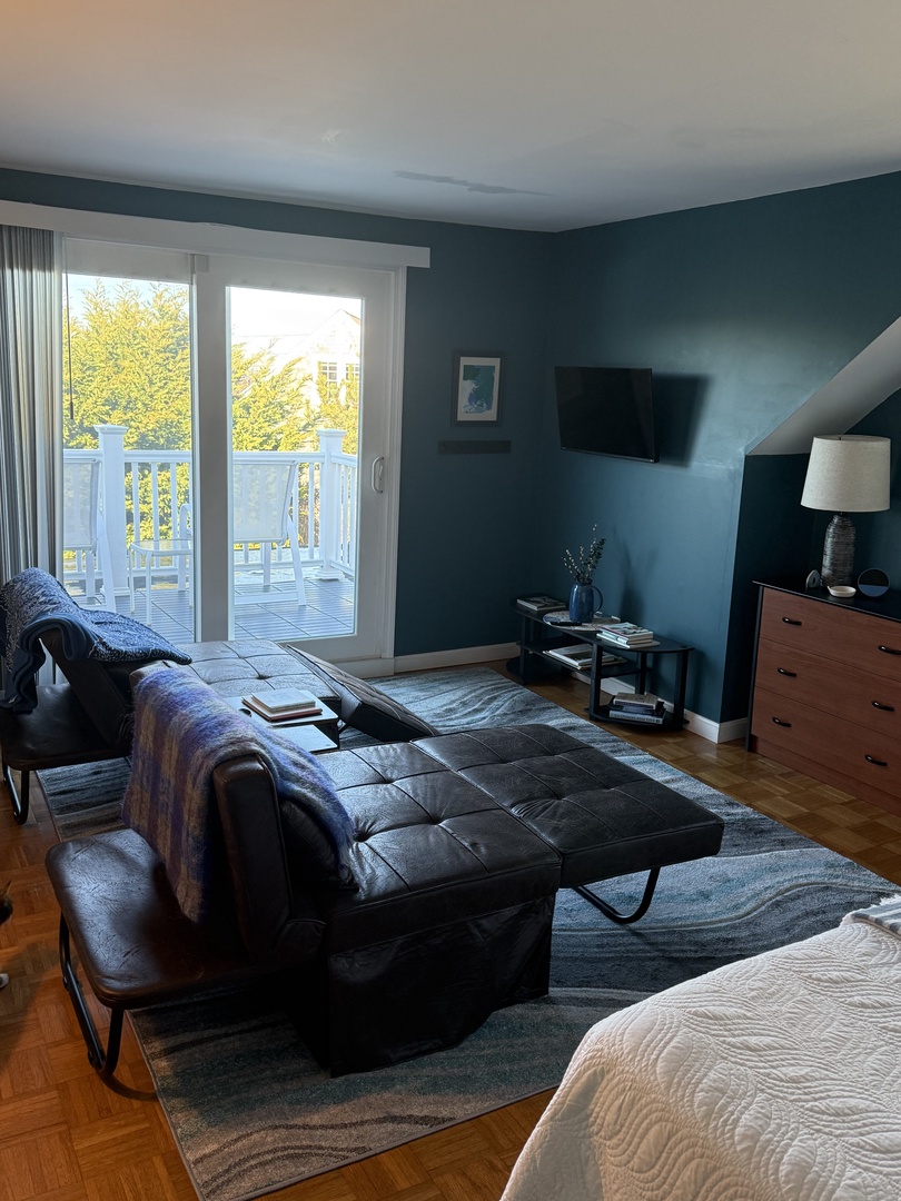 Your modern bedroom features crisp linens, stylish blue accents, and a peaceful city view to start each morning refreshed.