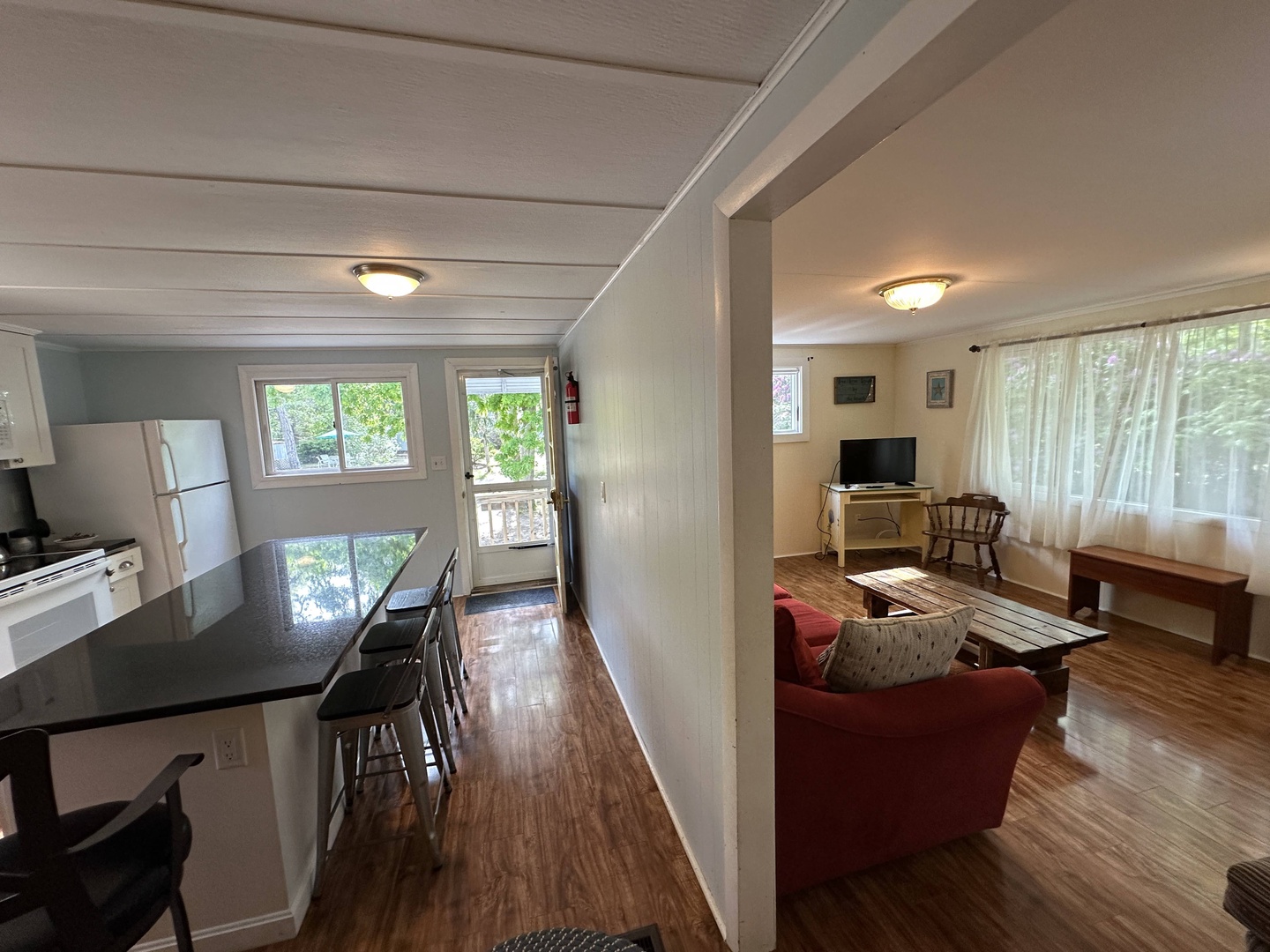 You'll love the open-concept design where your kitchen flows seamlessly into the cozy living room, creating perfect spaces for cooking and relaxing together.