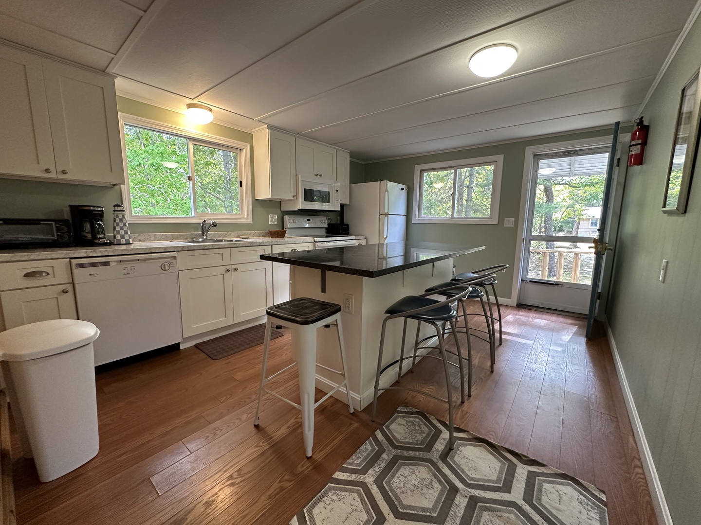 Your fully equipped kitchen invites culinary adventures with sleek counters, modern appliances, and a breakfast bar perfect for morning coffee or evening conversations.
