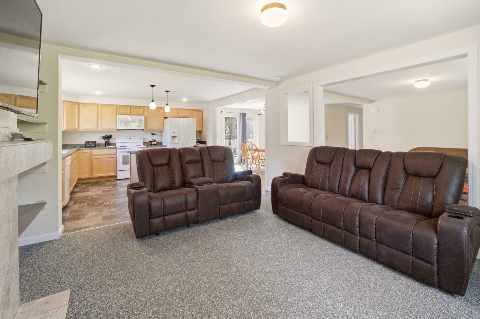 Stretch out in your spacious living room with plush leather recliners, perfect for movie nights after exploring the area.