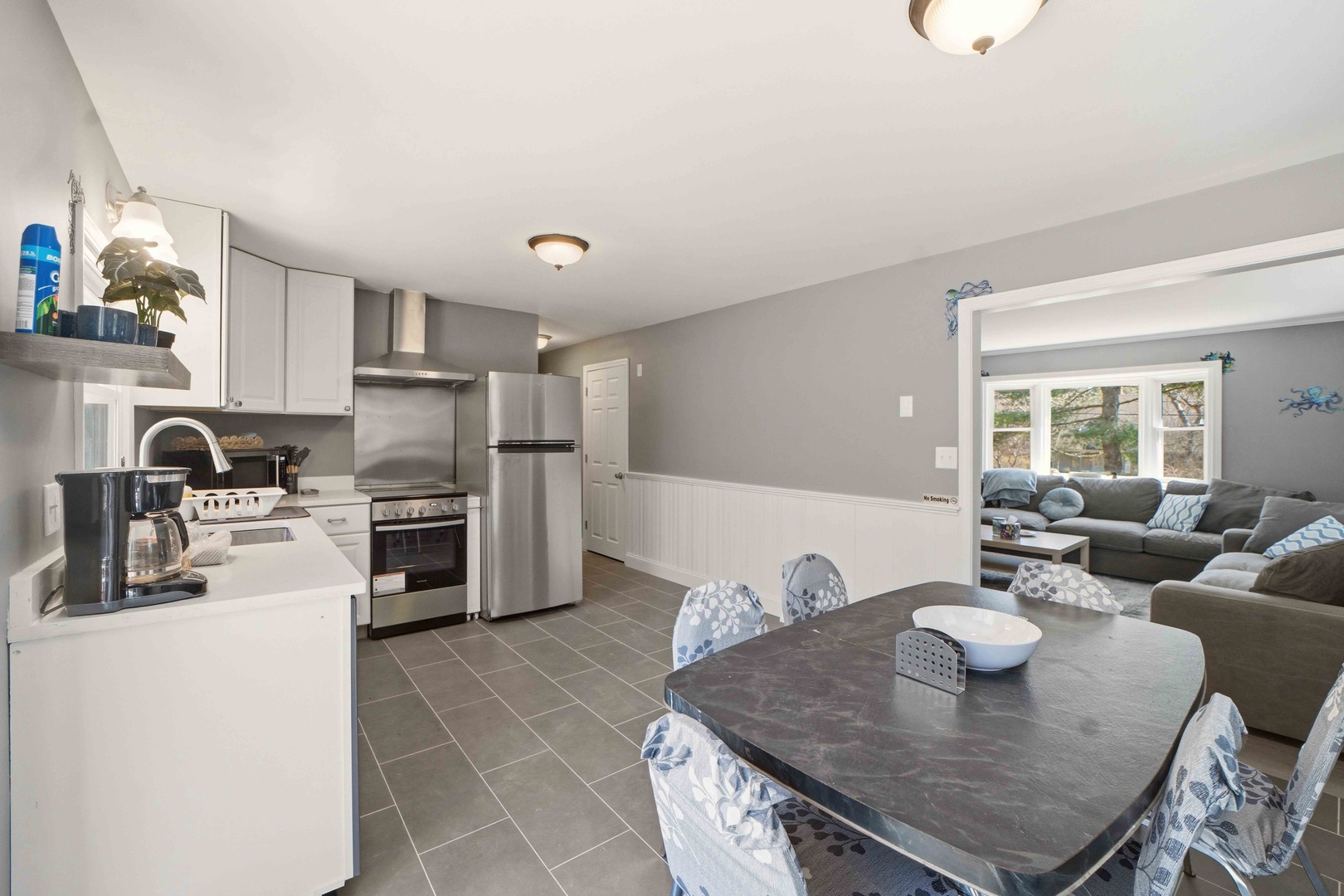 Your open-concept kitchen flows seamlessly into the cozy living area, perfect for gathering with loved ones while preparing meals.