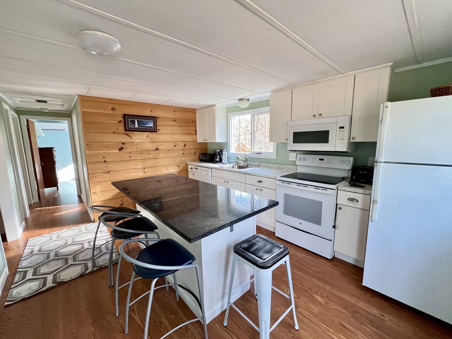 Your fully equipped kitchen features granite countertops, modern appliances, and a breakfast bar where you can start each morning with coffee.