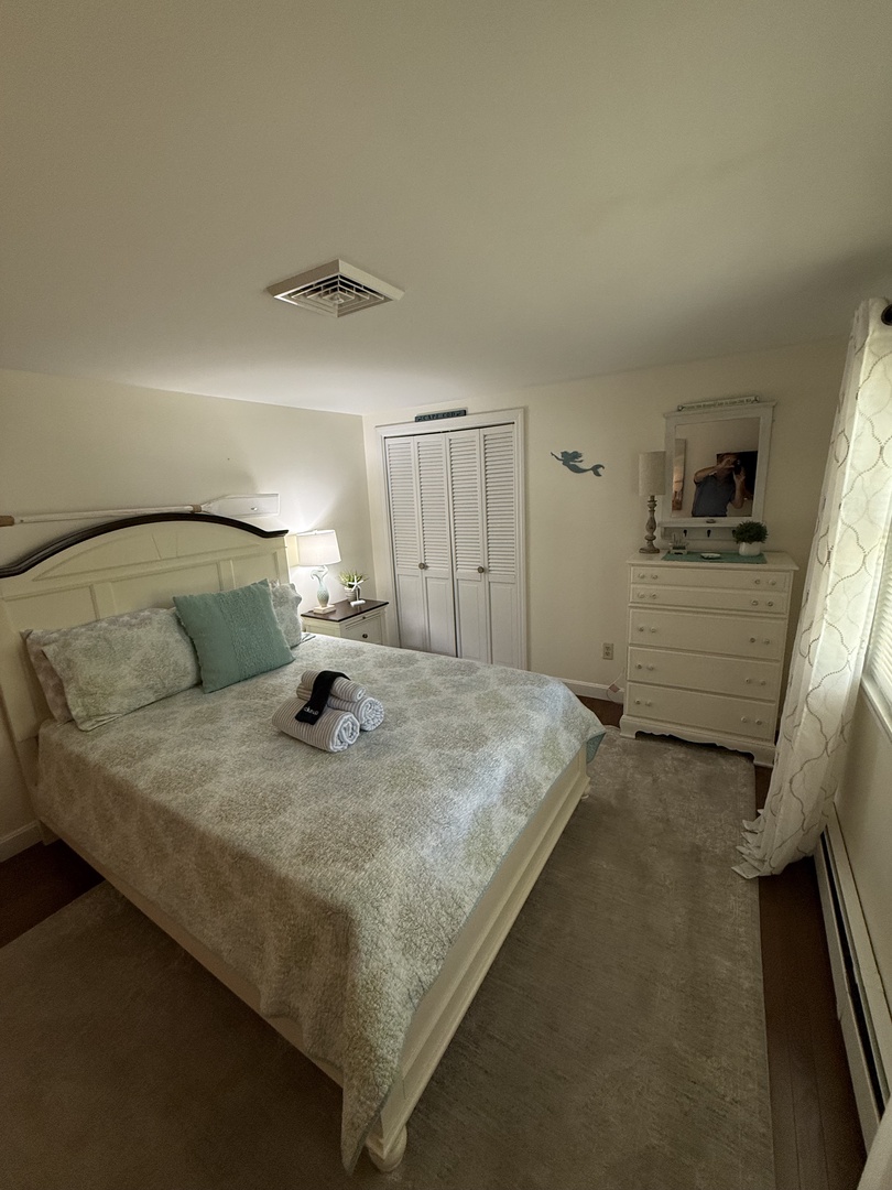 Step into your serene bedroom retreat, where crisp linens invite you to unwind. The soft coastal colors and thoughtful touches create a peaceful escape after a day of exploring.
