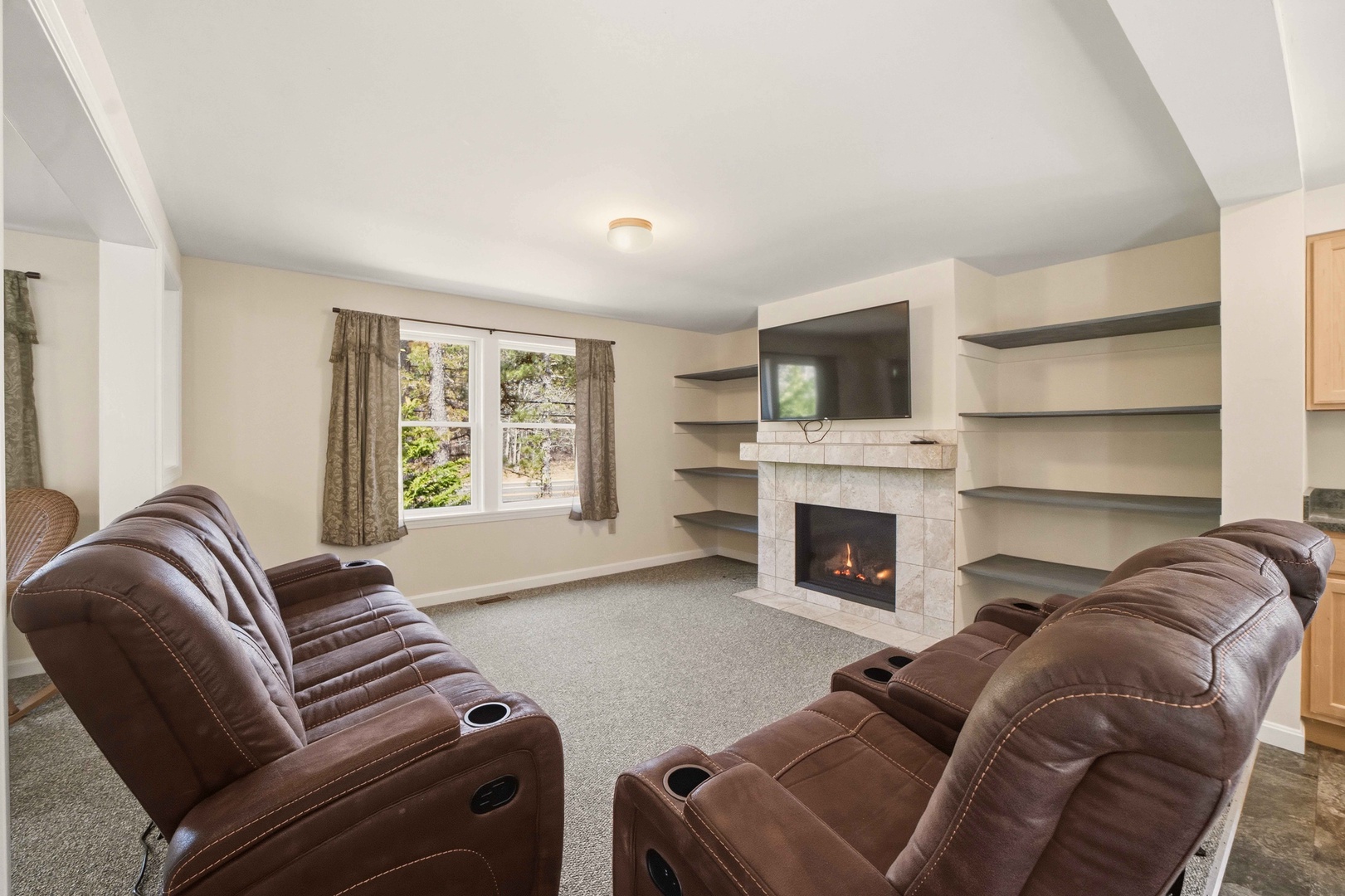Sink into plush leather recliners and warm up by your crackling fireplace in this cozy living room retreat.