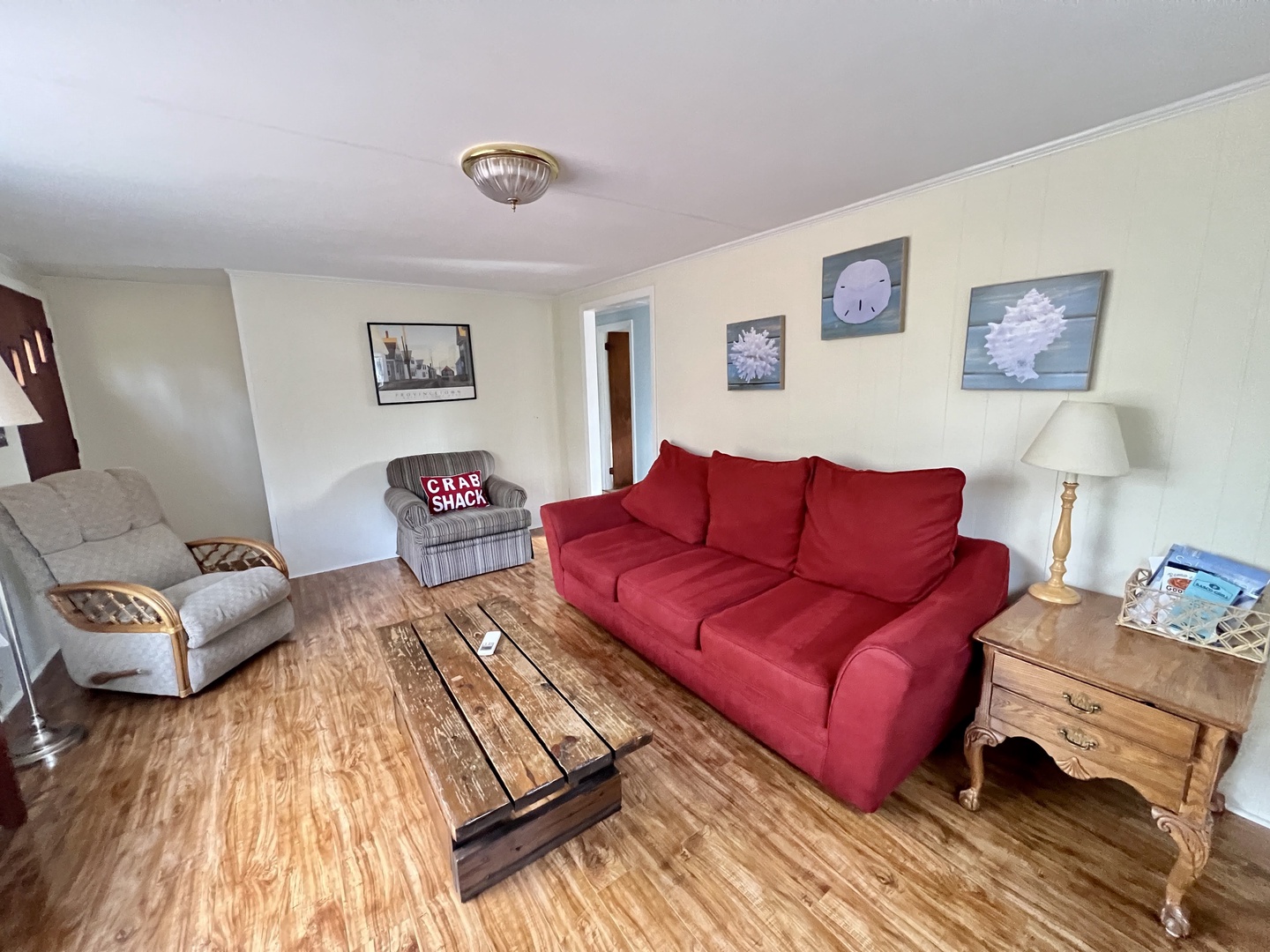 Sink into plush seating where rustic wood meets coastal charm—your perfect retreat for evening conversations and morning coffee.