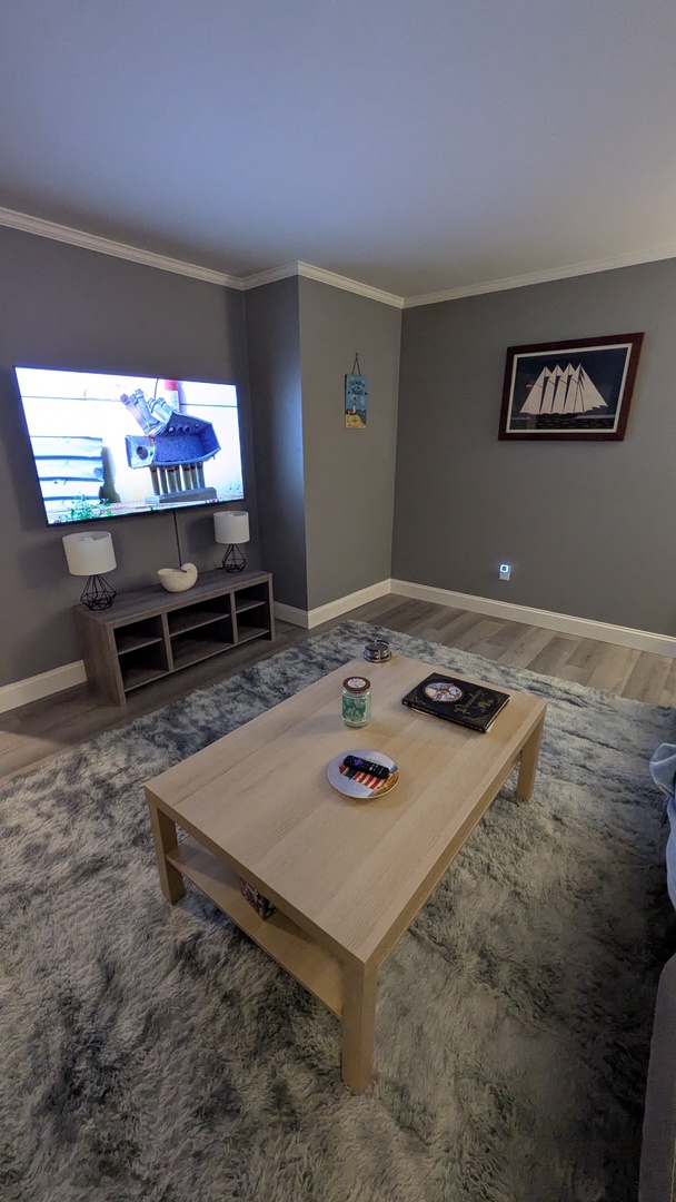 Relax in your stylish living room with nautical touches, cozy seating, and entertainment ready for your perfect getaway.