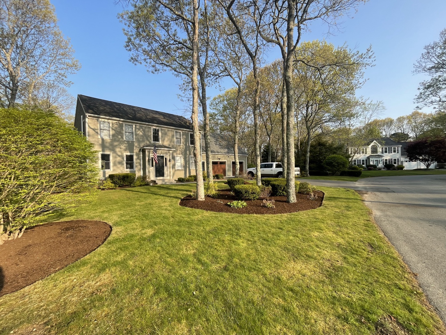 Beautiful colonial-style home nestled in a quiet residential neighborhood with mature trees and well-maintained landscaping.