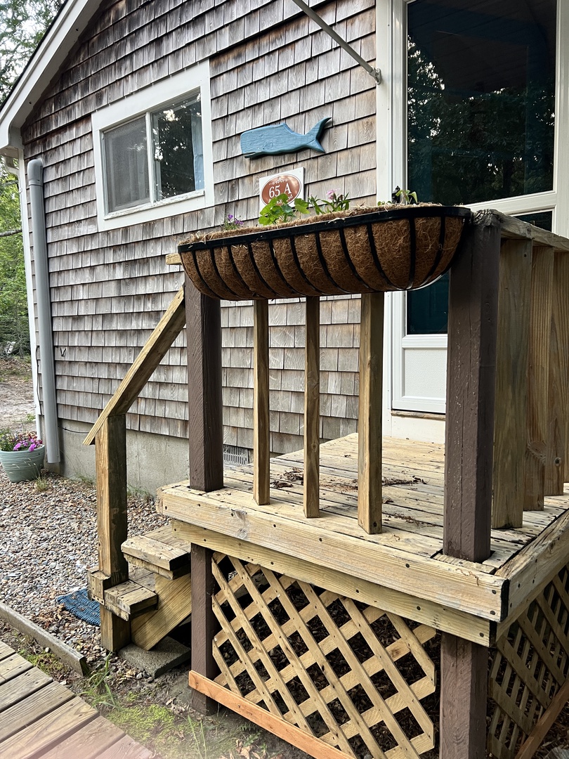Step onto your private wooden deck overlooking the sparkling pool—perfect for morning coffee or evening relaxation in your serene outdoor retreat.
