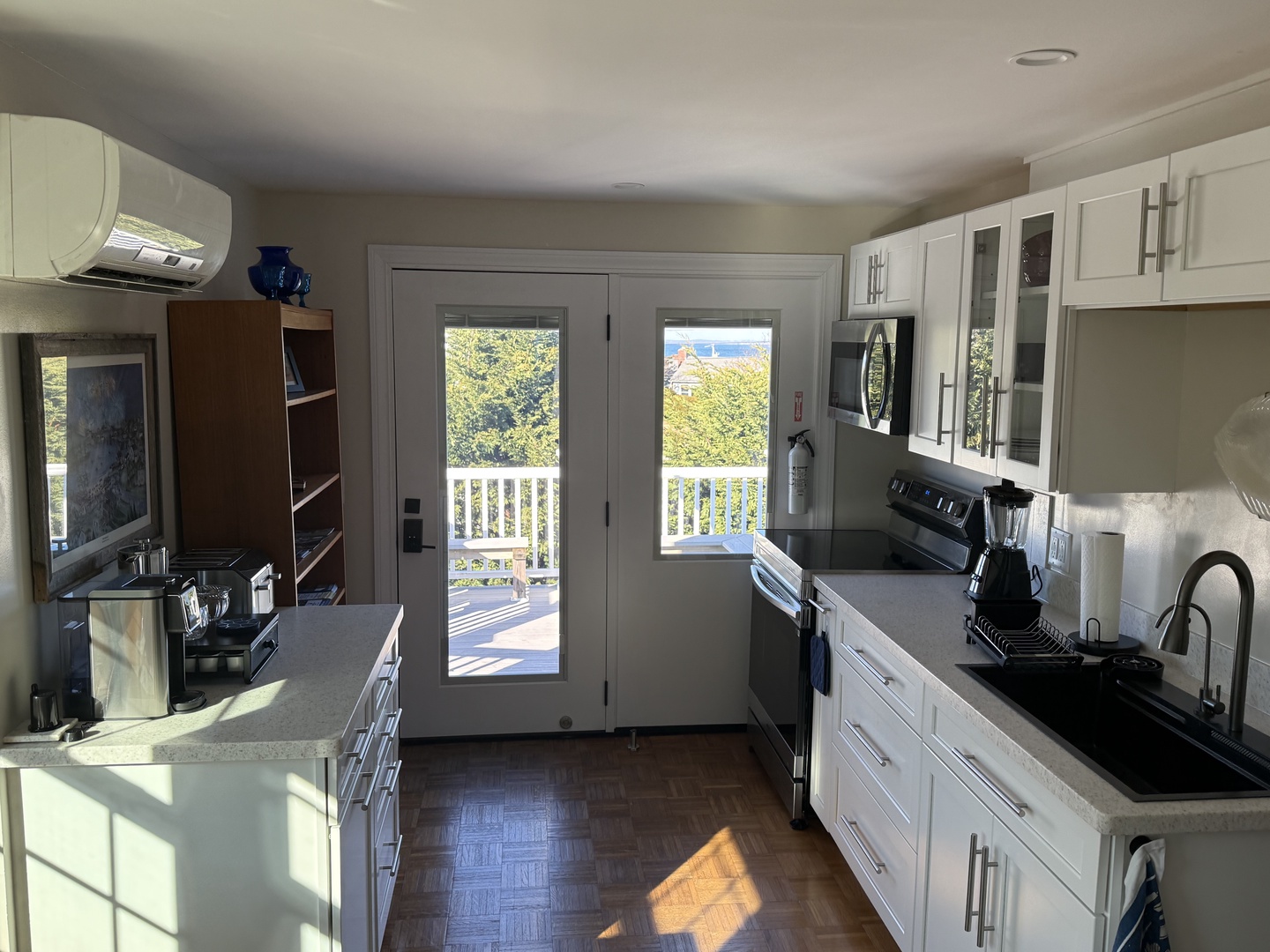 Cook with stunning views through French doors that open to your private deck, surrounded by modern appliances and bright natural light.