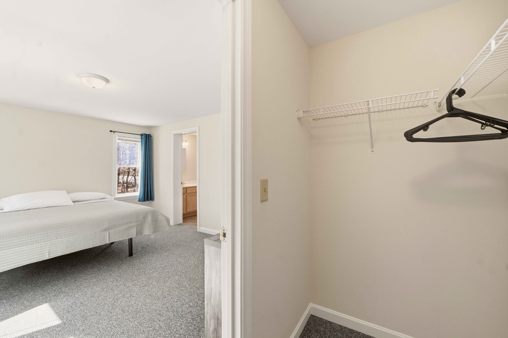 Your spacious walk-in closet offers plenty of room to organize your belongings with convenient wire shelving and hangers ready for your stay.