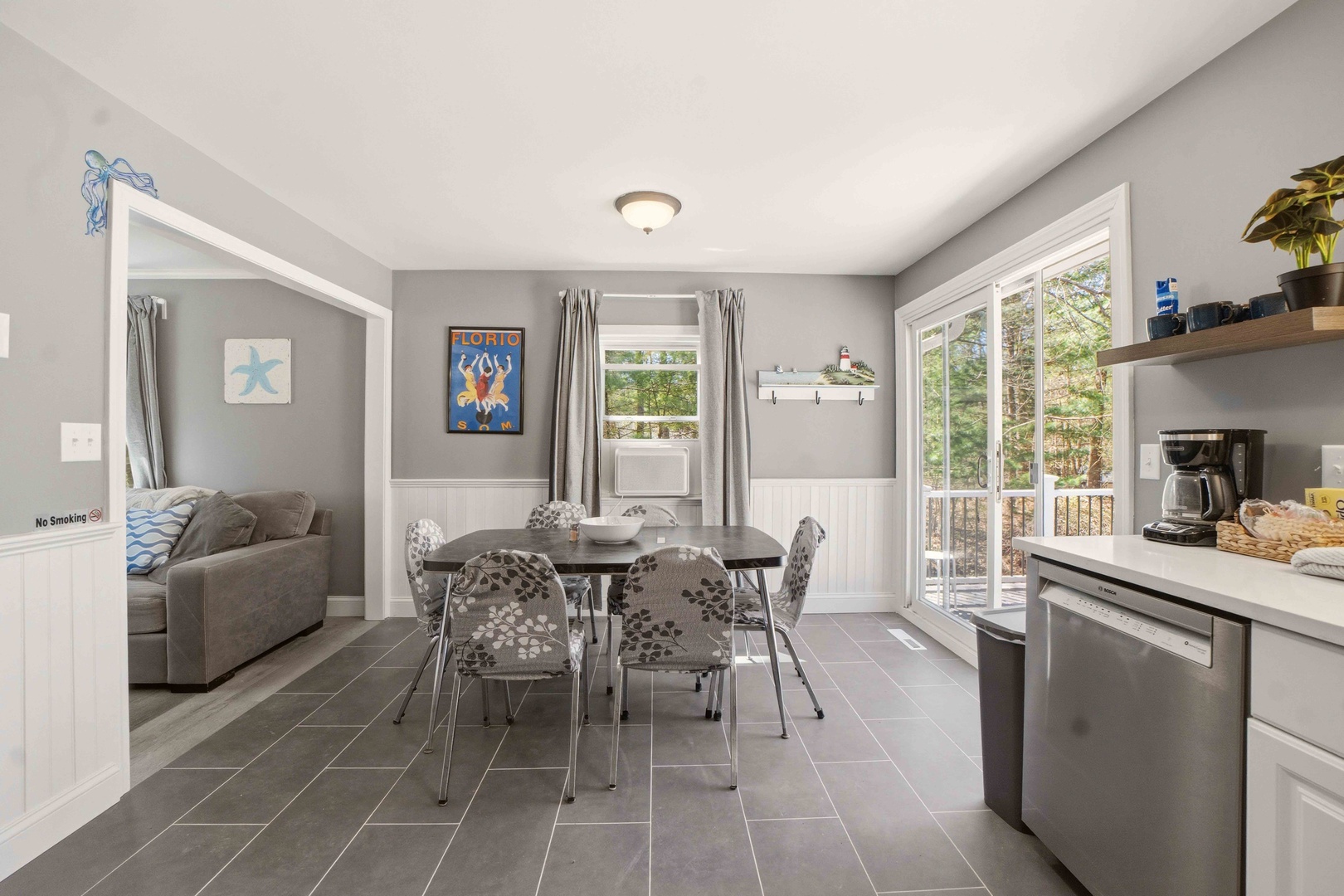Gather around your stylish dining table where morning coffee and evening conversations flow naturally in this bright, modern space.