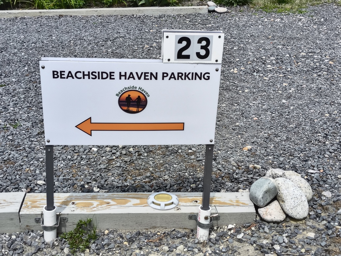 Parking sign marking space 23 at Beachside Haven, with directional arrow guiding guests to their designated parking area upon arrival.