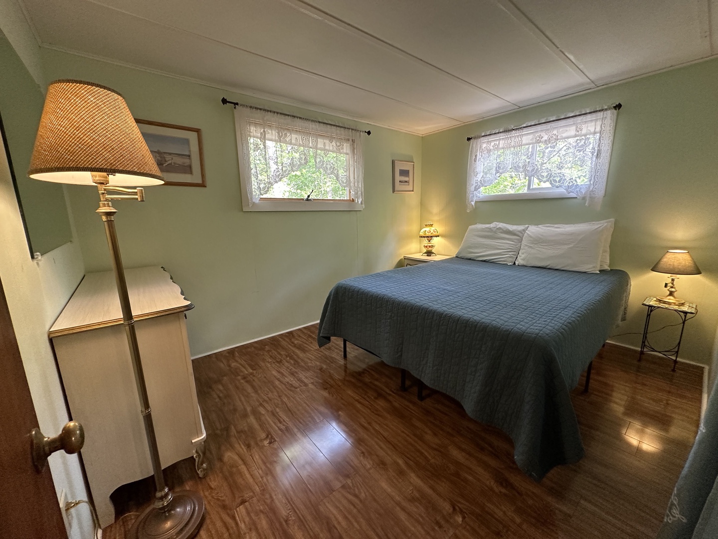 Sleep peacefully in your cozy bedroom featuring soft lighting and garden views through dual windows.