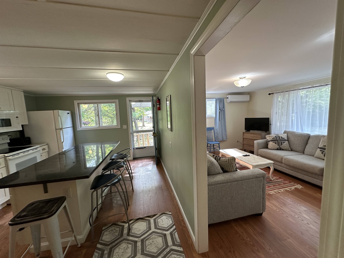 Your open-concept retreat features a fully equipped kitchen flowing into a cozy living room, perfect for relaxing after exploring the area.