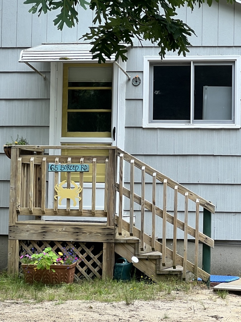 Welcome to your charming beach cottage, featuring a sunny deck where you can sip morning coffee and watch the world go by.