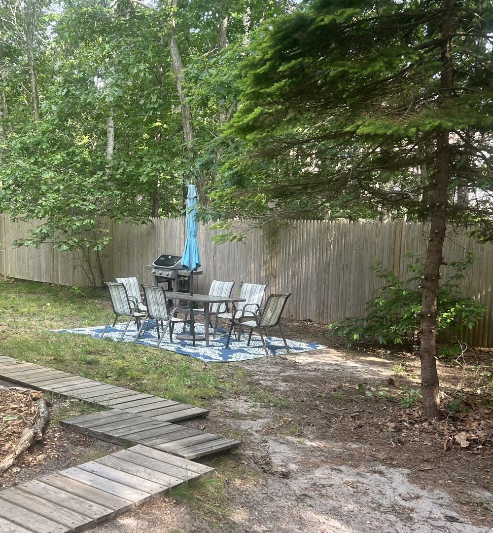 Relax in your private backyard oasis with outdoor dining and BBQ under leafy shade trees.