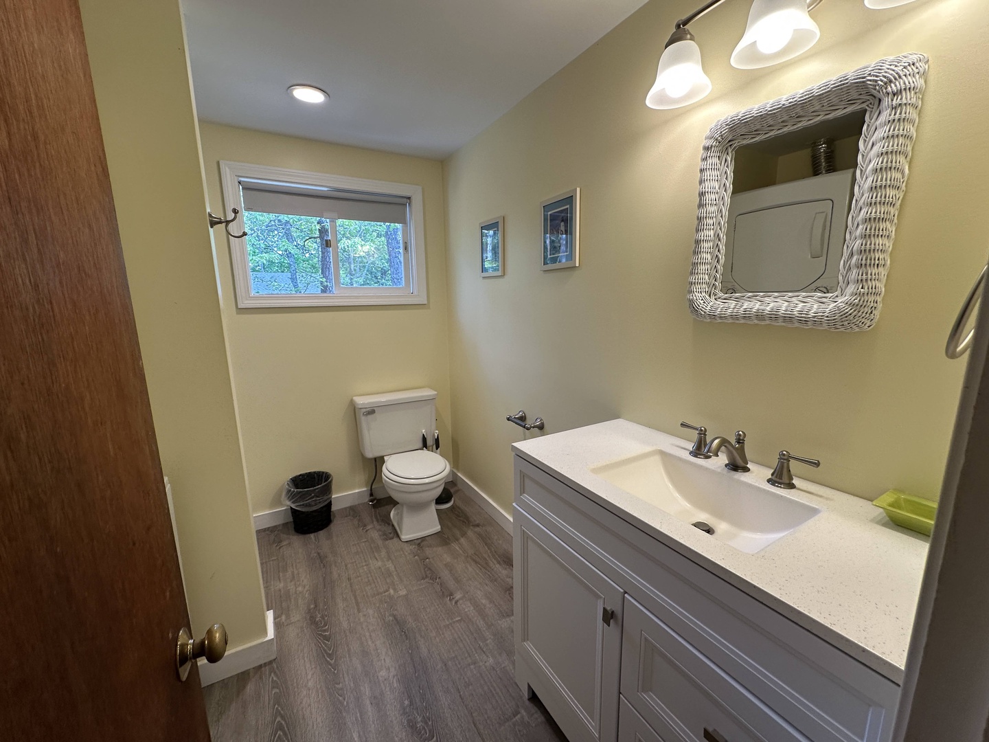 Step into your bright, modern bathroom featuring beautiful wicker mirror details and garden views that create a serene morning routine.