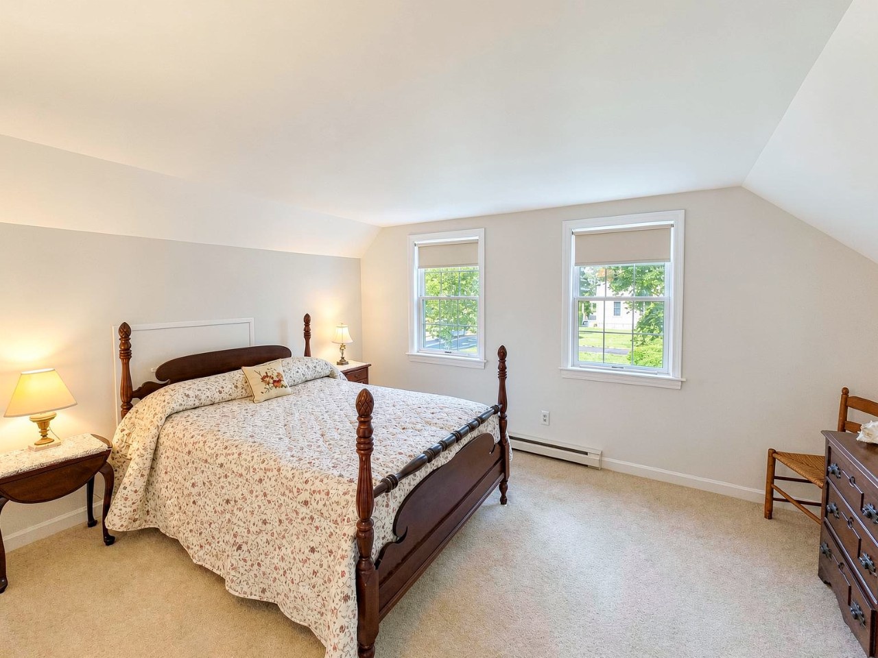 Sink into the plush bed and wake to natural light streaming through dual windows framing peaceful views. Your restful retreat awaits.