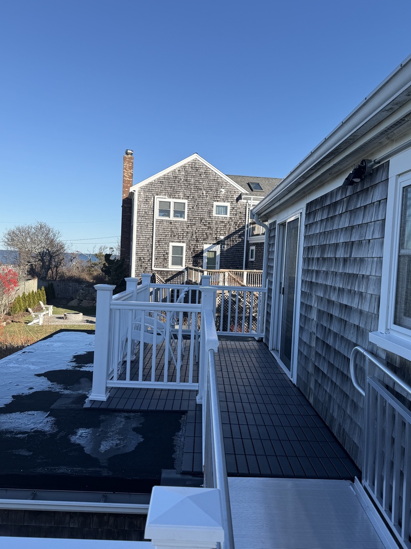Water view property with outdoor decking and panoramic water views under clear blue skies.