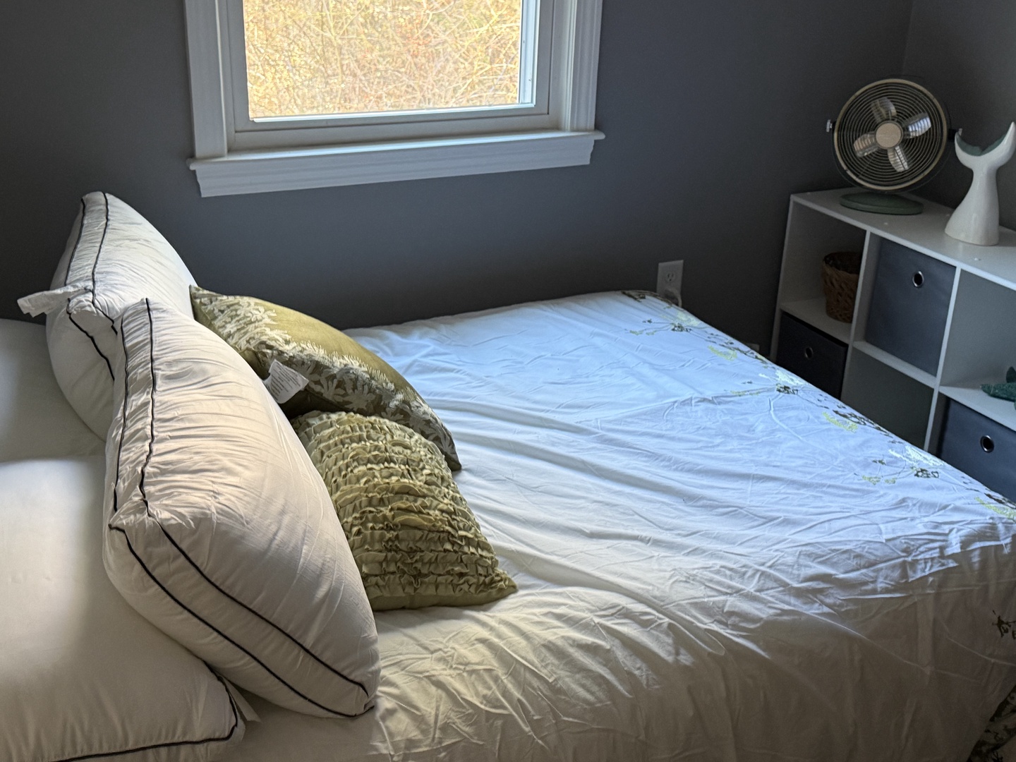 Drift off in this cozy bedroom with soft linens, natural light, and organized storage to keep your belongings tidy.