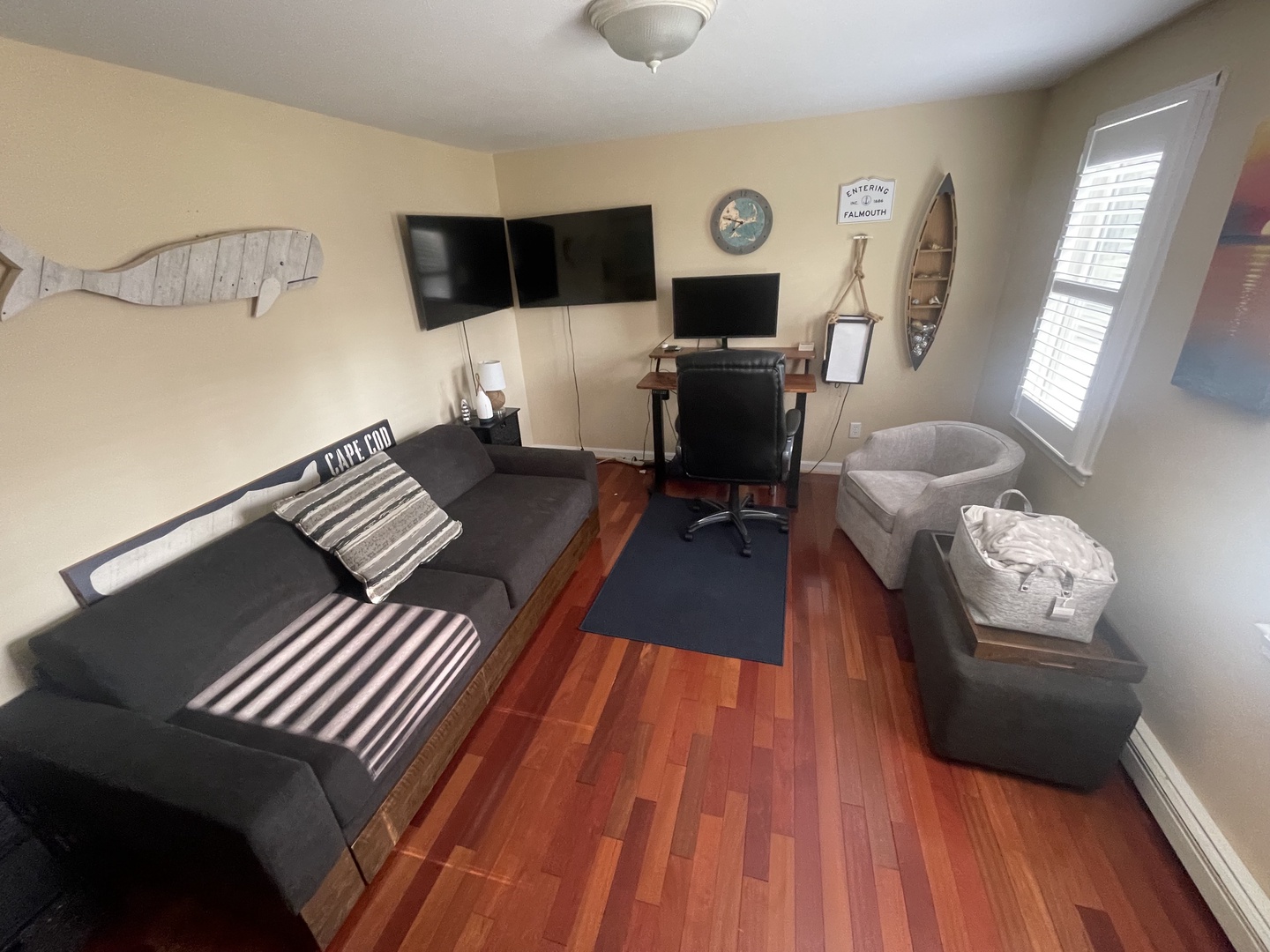 Relax in your cozy living space with nautical charm, featuring comfortable seating and modern entertainment setup perfect for unwinding after your adventures.