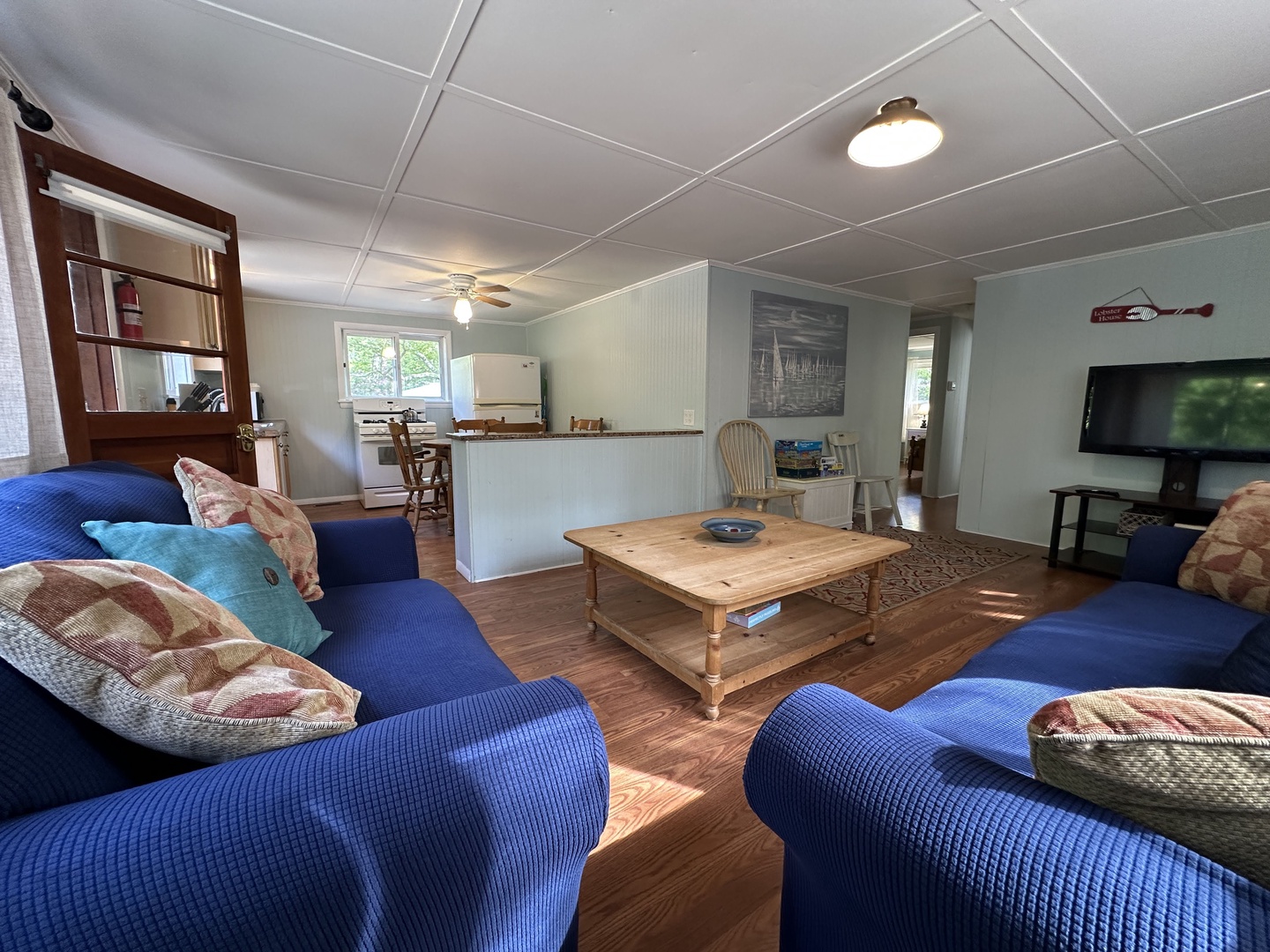 Settle into your comfortable living room with plush blue seating, perfect for movie nights on the flat-screen TV or relaxing with loved ones.