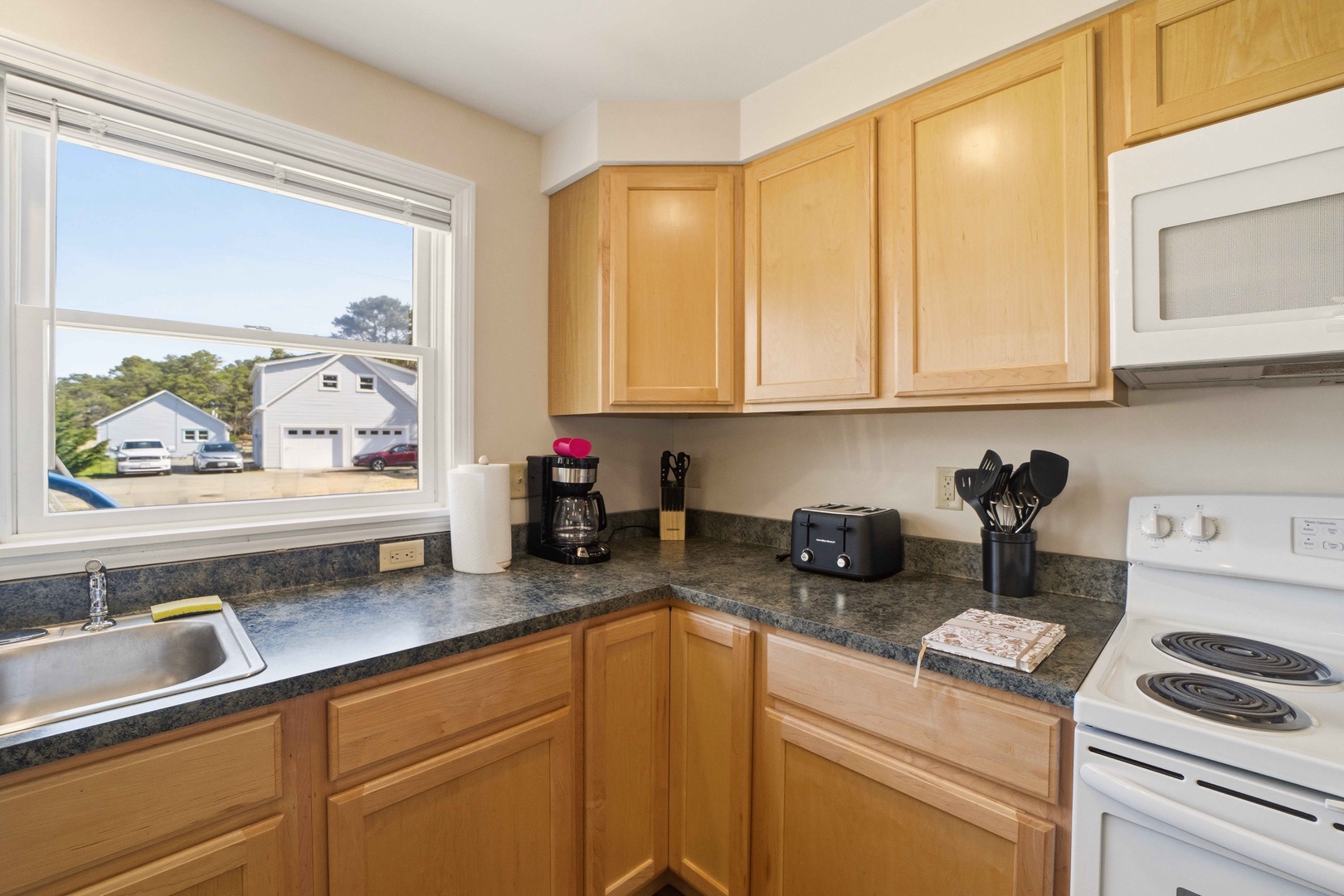 Your fully equipped kitchen features granite countertops, modern appliances, and coffee maker for comfortable meal preparation.