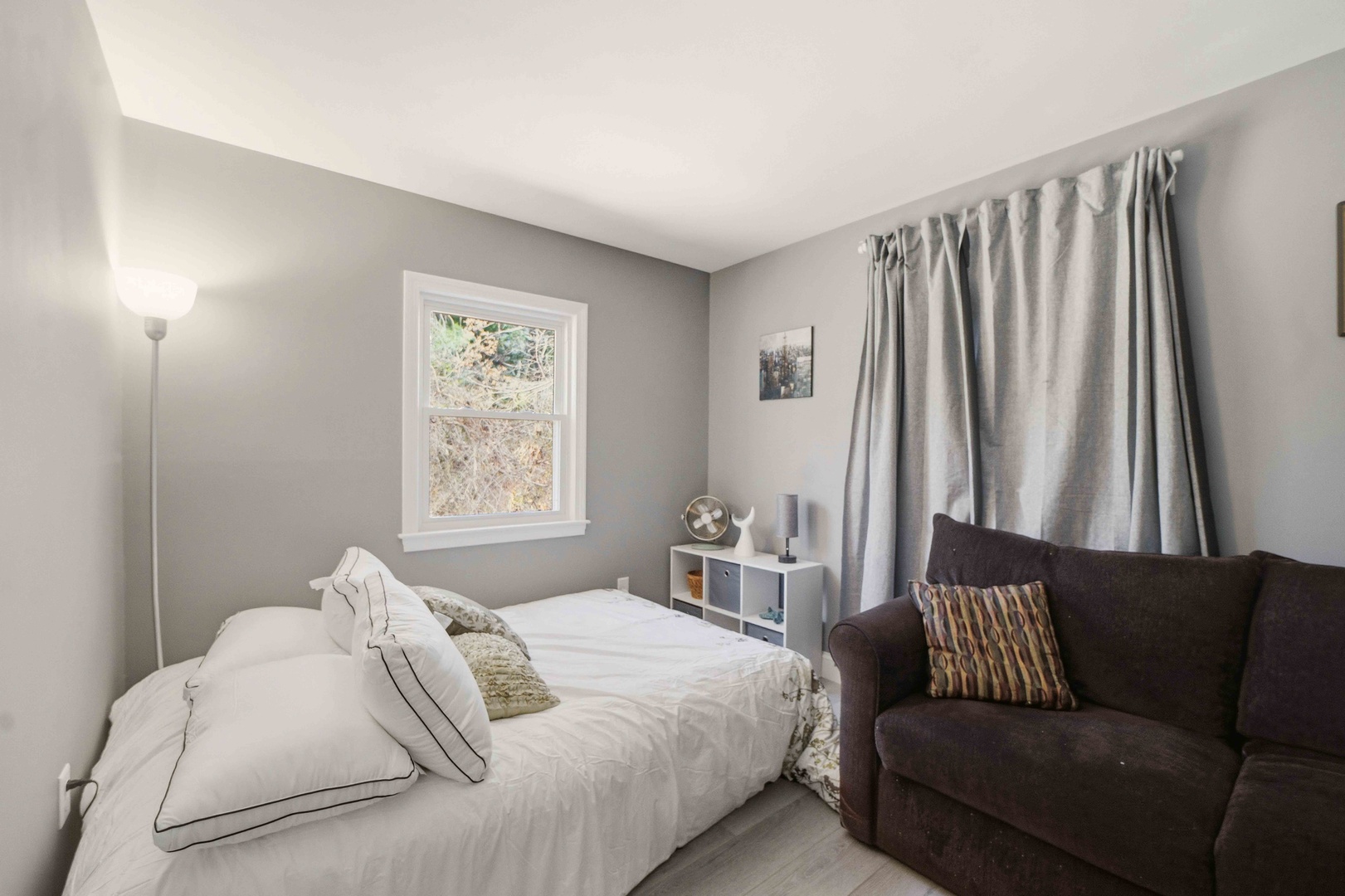 Sink into your comfortable bed or relax on the cozy sofa in this peaceful bedroom, perfectly designed for restful nights and leisurely mornings.