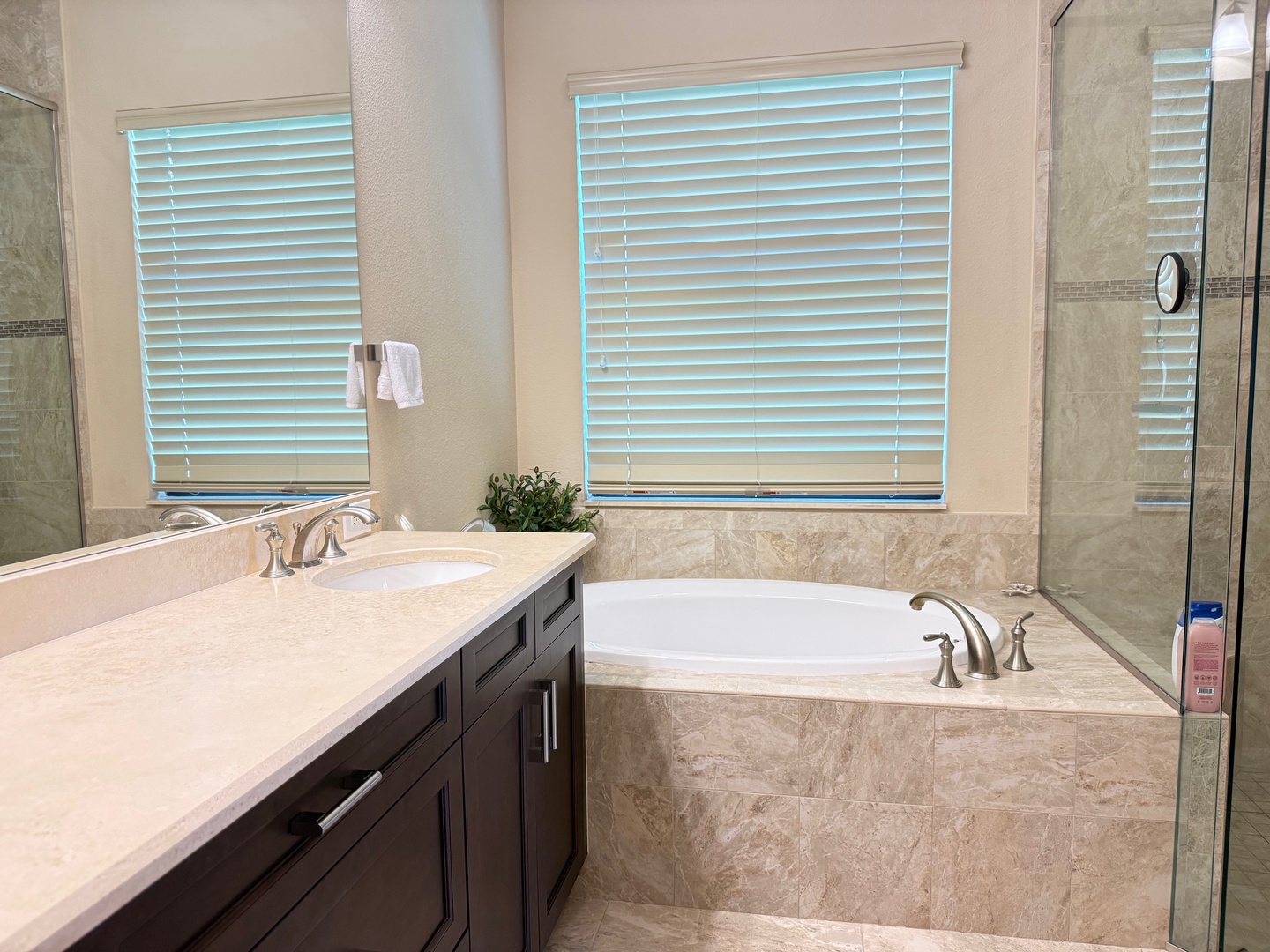 Unwind in this luxurious master bath featuring a deep soaking tub and elegant marble details for your ultimate relaxation.