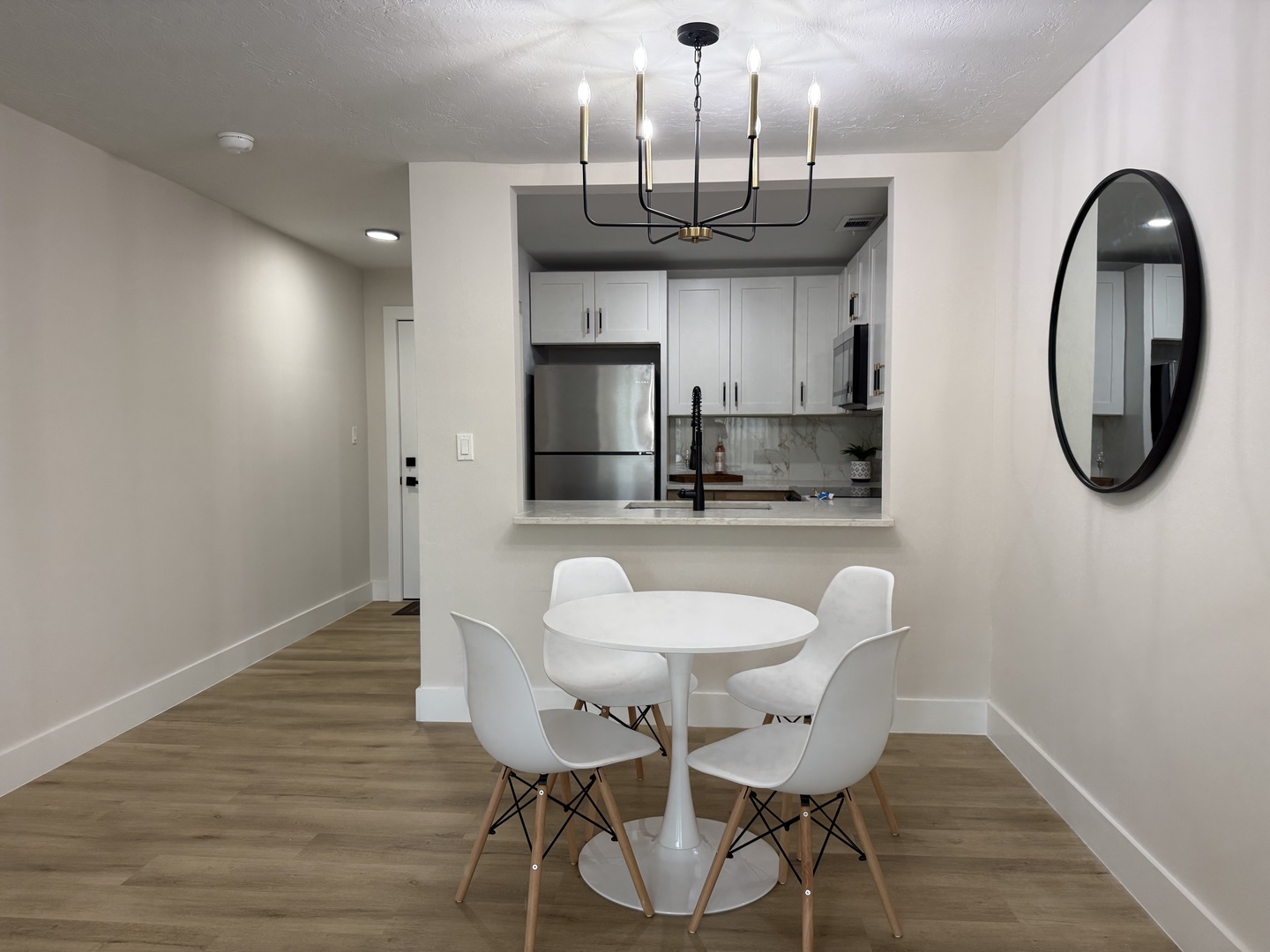 Your stylish dining area flows seamlessly into the modern kitchen, creating the perfect space for memorable meals and conversations.
