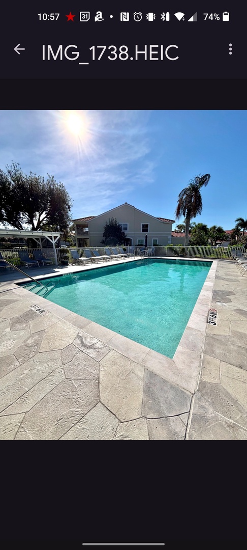 Dive into crystal-clear waters under sunny skies. Your tropical escape awaits with this inviting pool surrounded by swaying palms.