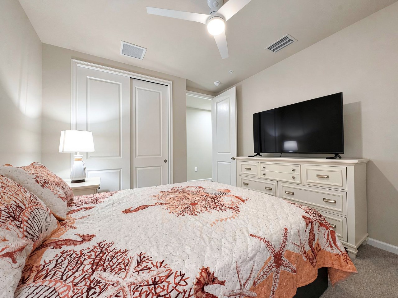 Unwind in your tranquil bedroom with a plush bed, vaulted ceiling, and modern amenities. Your coastal retreat awaits.
