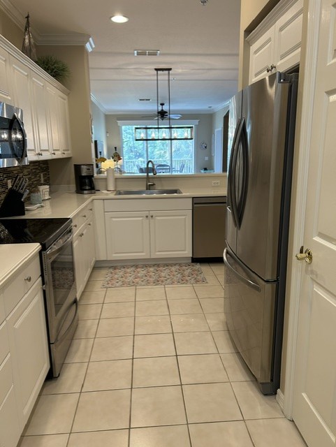 Your fully equipped kitchen features stainless steel appliances, ample counter space, and a bright window above the sink for natural light while you prepare meals.