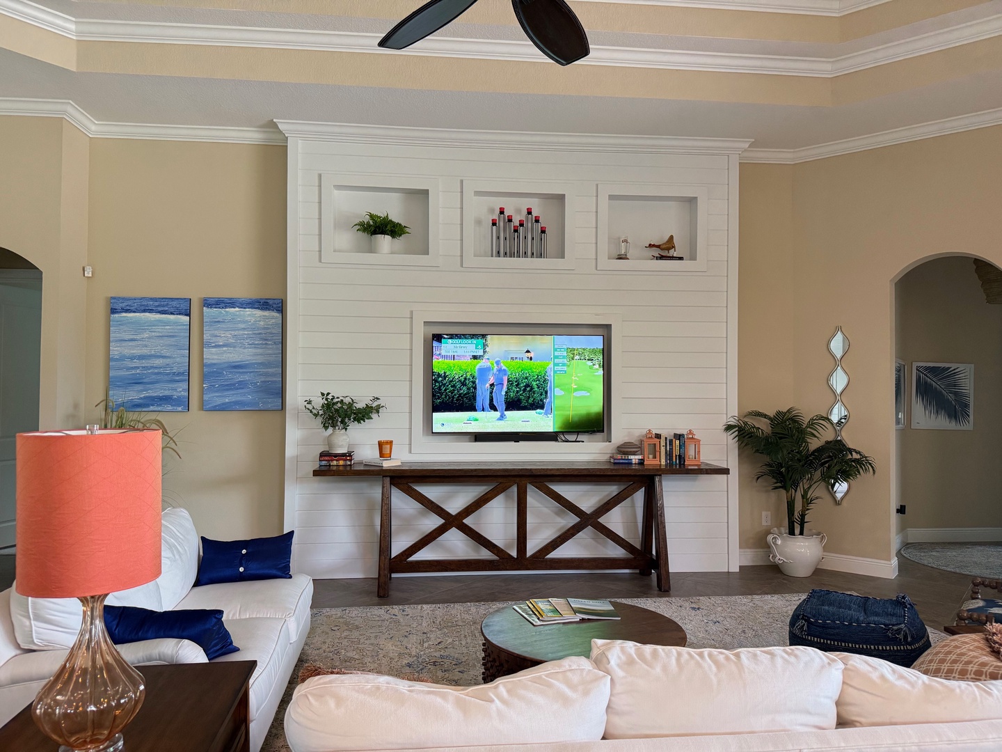 Unwind in your elegant living space with plush seating, built-in entertainment center, and coastal-inspired decor perfect for relaxing evenings.
