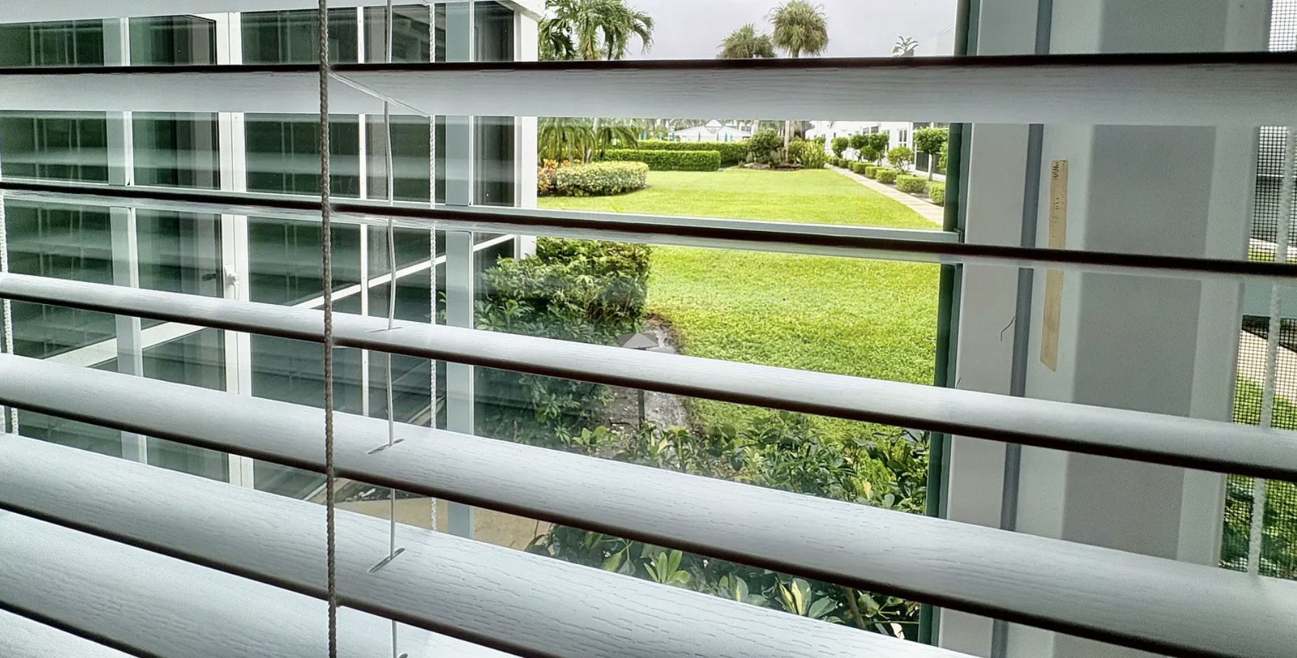 Modern property featuring landscaped gardens, open green spaces, and contemporary architecture with easy access to shared outdoor areas.