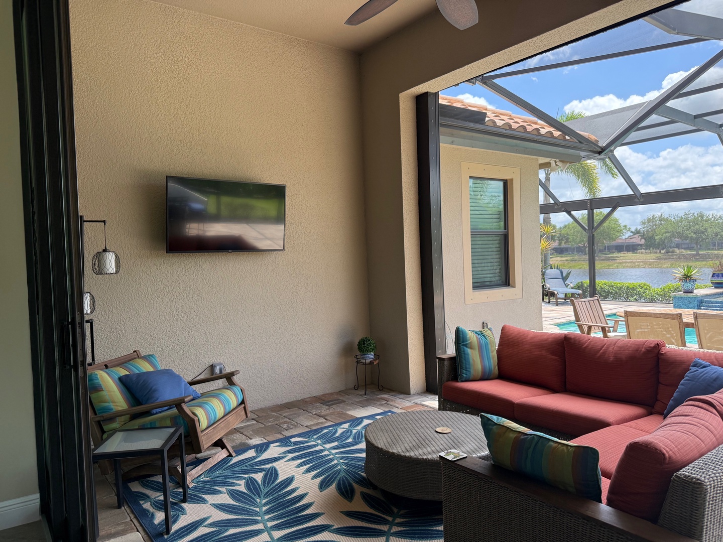 Relax in your covered lanai with plush seating, watching TV or gazing at the sparkling pool and lake beyond.