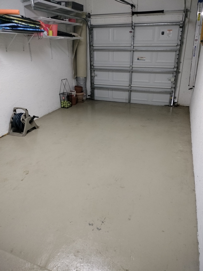 Secure garage space with convenient storage shelving and ample room for your vehicle and belongings.