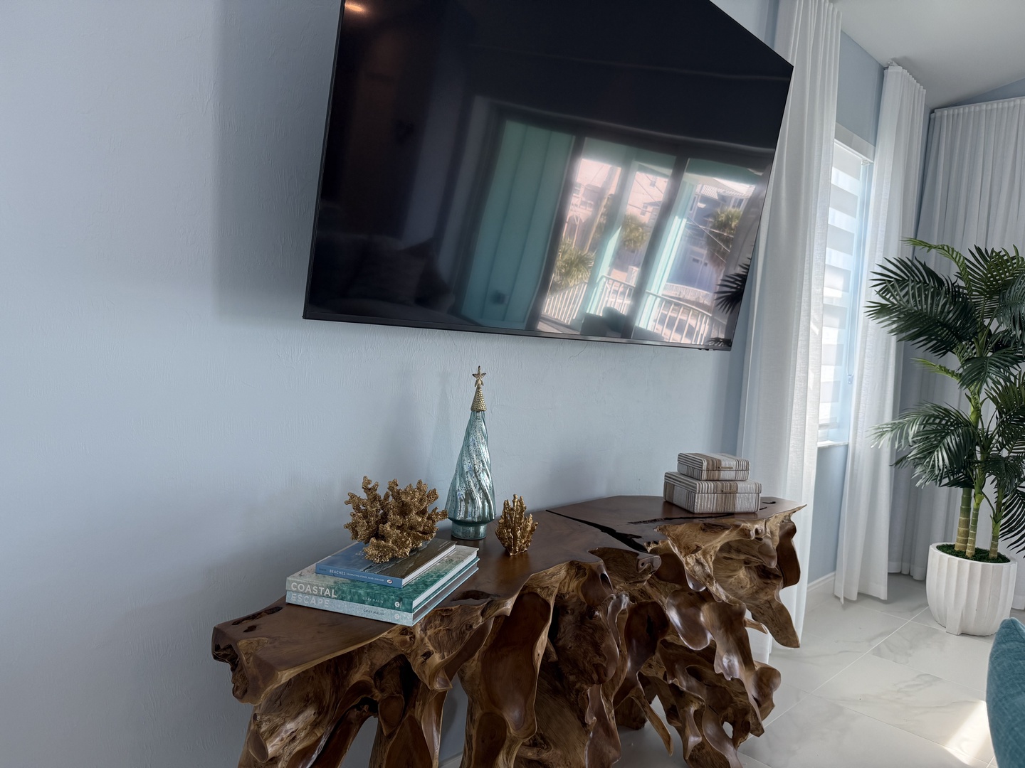 Unwind in your stylish living space with natural wood accents and modern entertainment system perfectly positioned for relaxation.