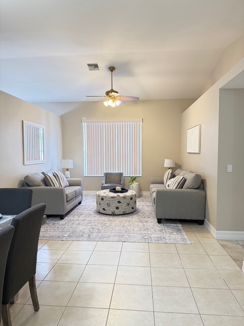 Step into your bright, contemporary living room where plush seating and warm lighting create the perfect space to unwind after exploring.