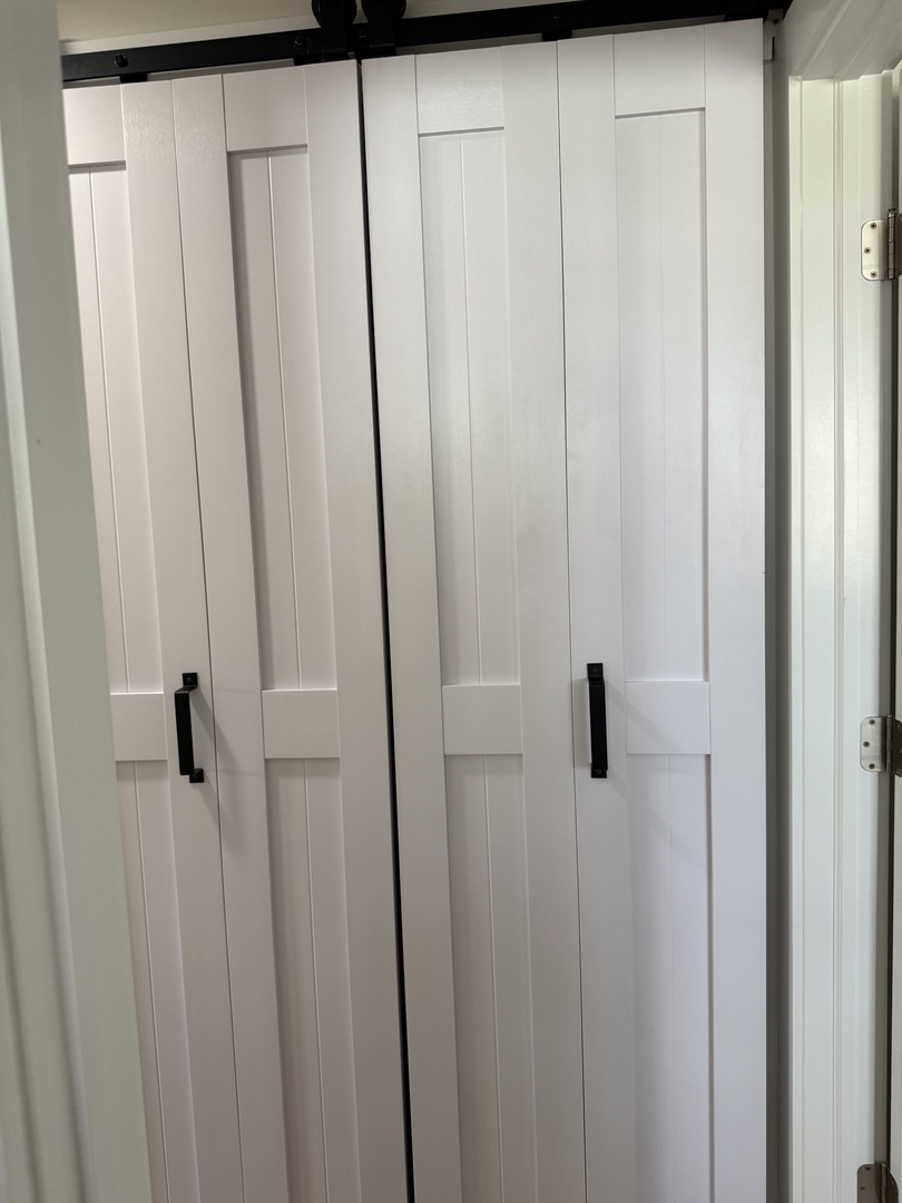 Store your belongings in style with these spacious white drawers, offering ample organized storage for your vacation wardrobe and personal items.