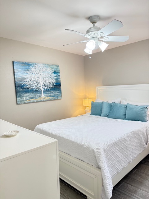 Second Bedroom King Your peaceful bedroom retreat features a plush white bed with ocean-blue accents, creating the perfect sanctuary for restful nights.